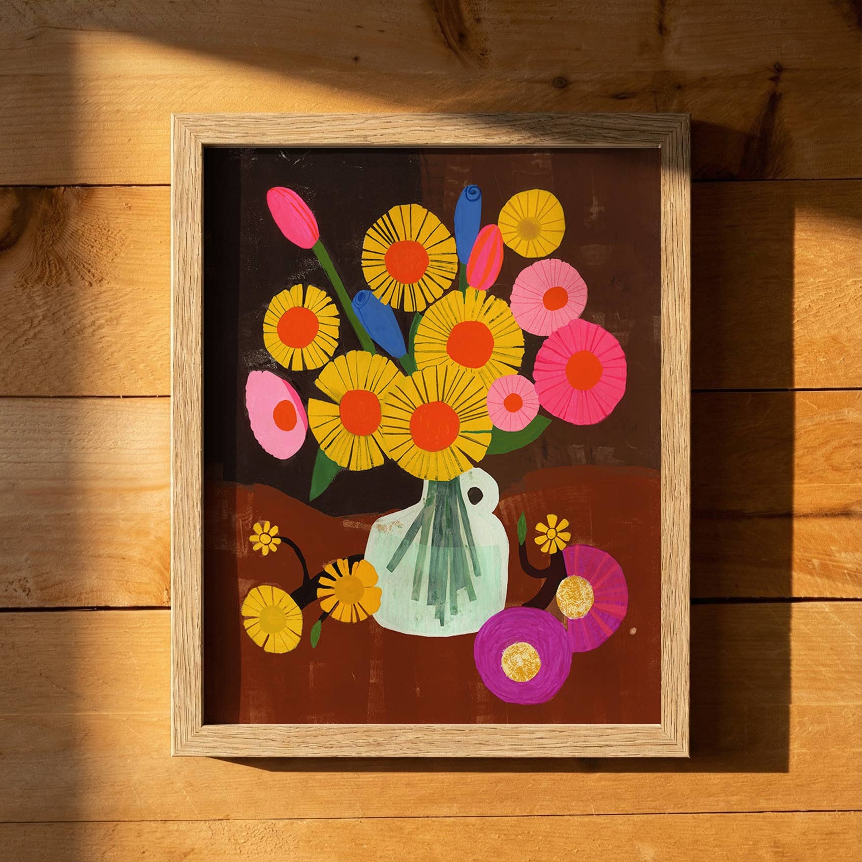 Framed artwork of colorful flowers on a wooden surface