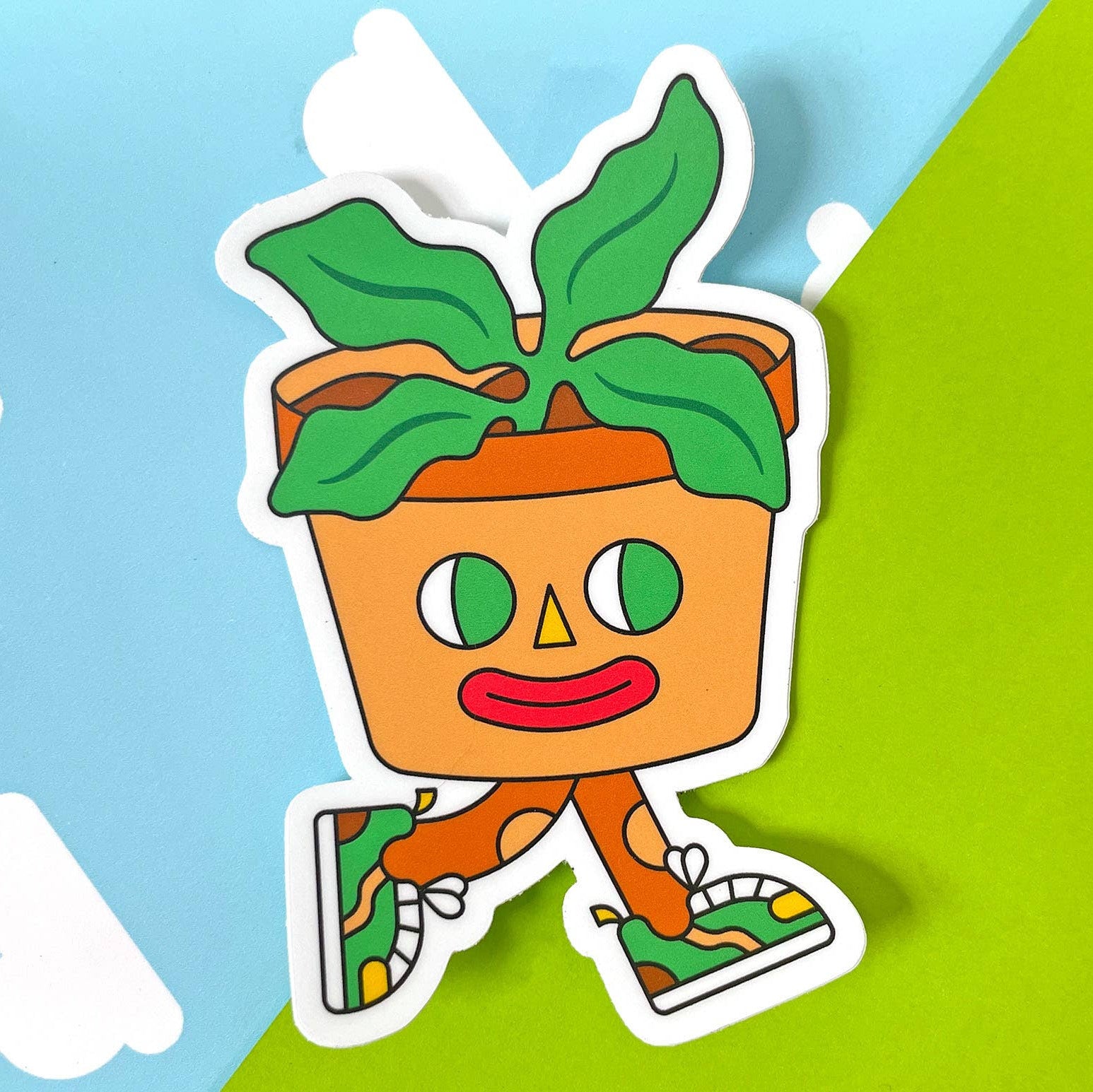 Cartoon character in a pot with green leaves on a blue and green background