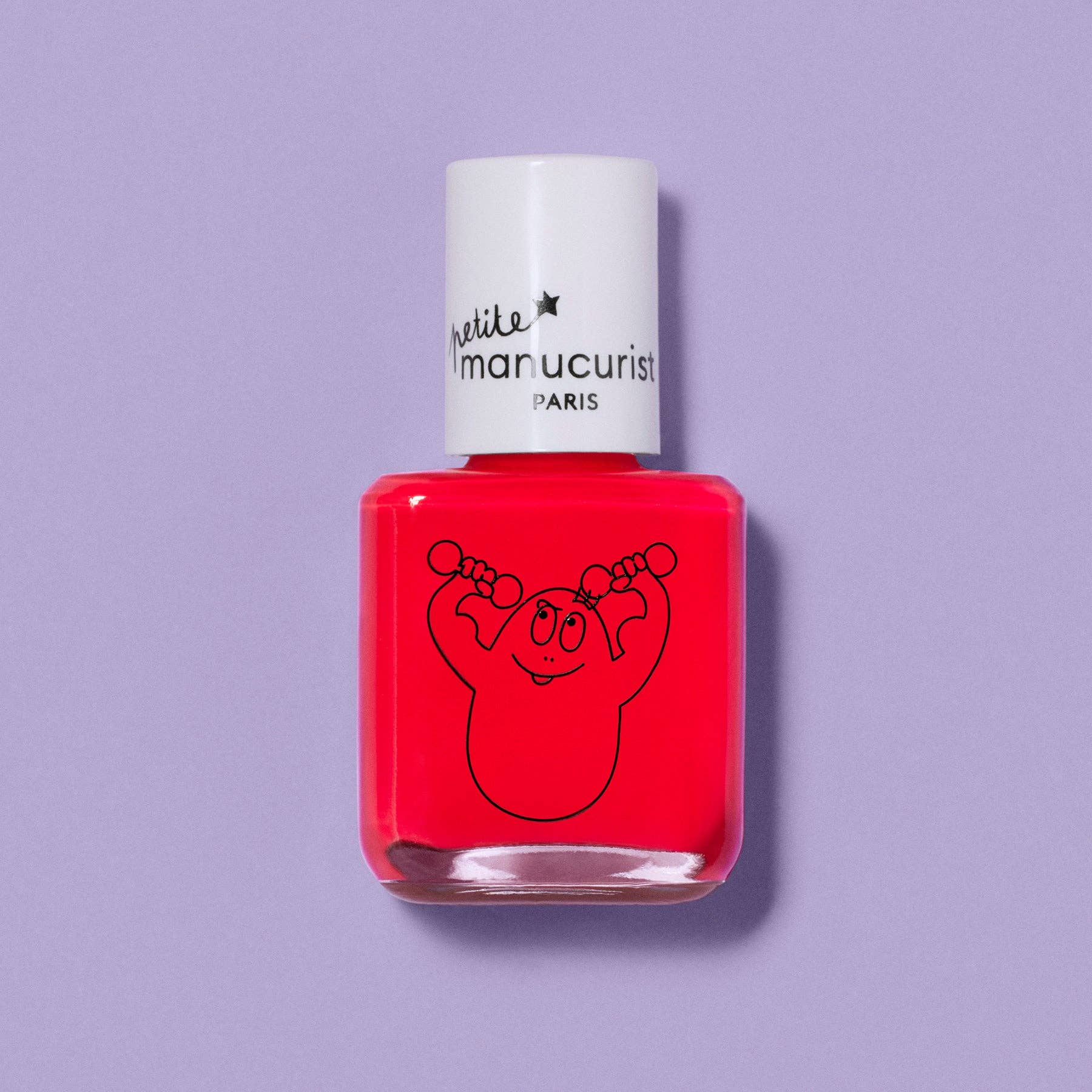 A bottle of nail polish with bright red polish and a white cap, featuring a black line art graphic of a cartoon character lifting weights. The brand name 'nail like a pro manicurist PARIS' is printed on the cap.