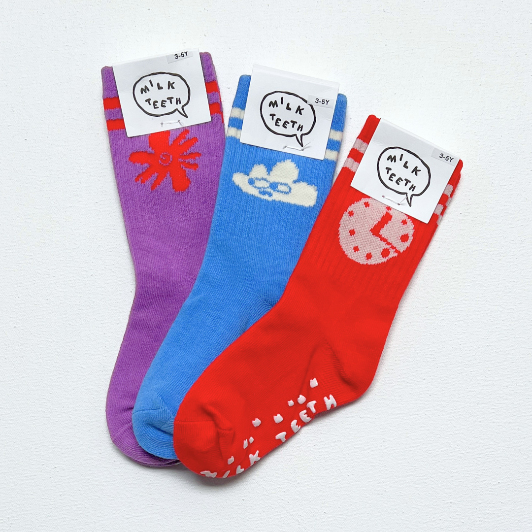 Three colorful socks with cartoon designs and labels on a white background