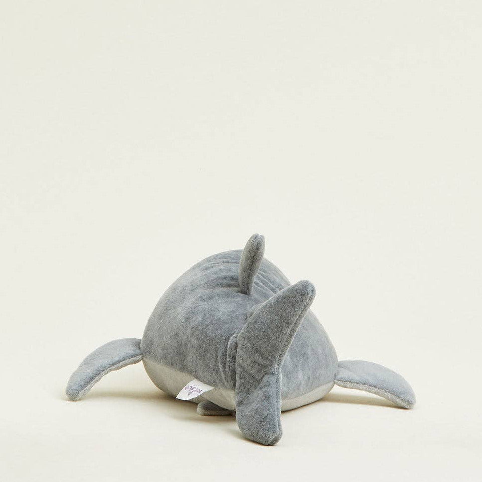 Gray plush toy resembling a dolphin on a light gray background