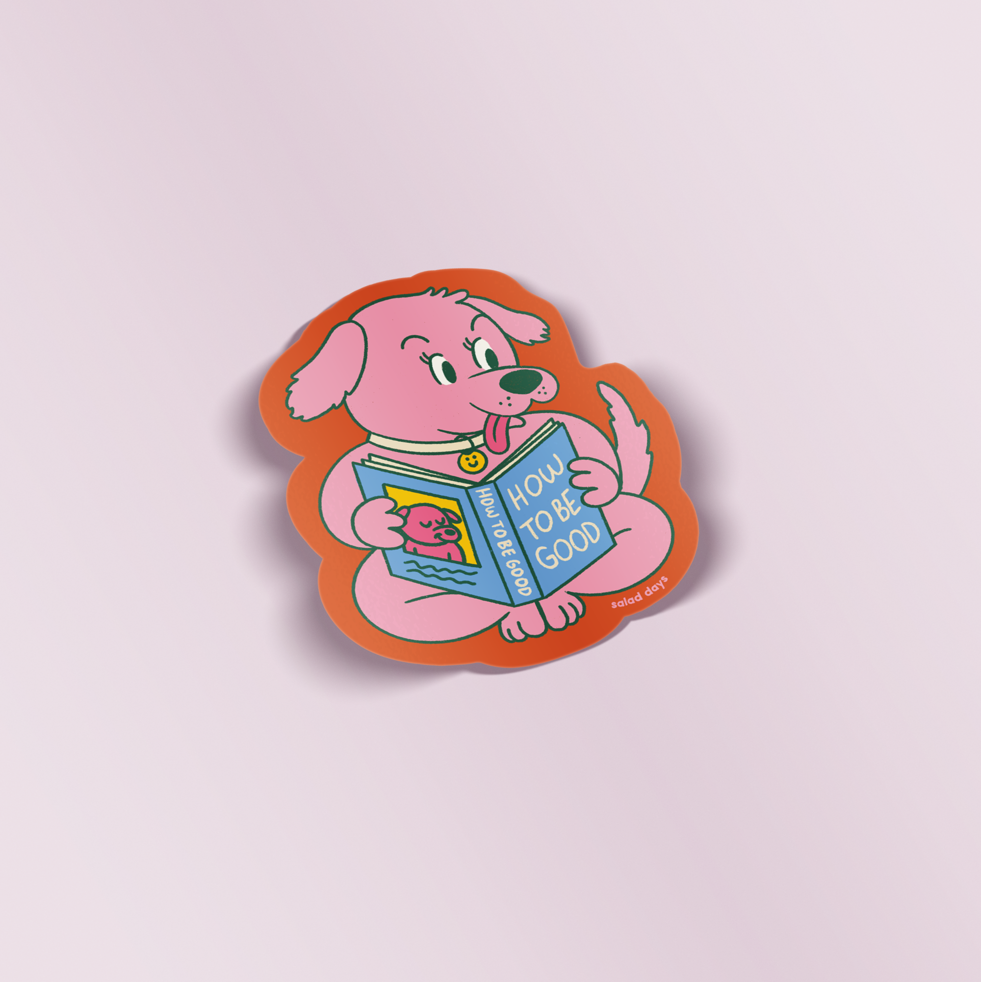 Sticker of a pink dog holding a book titled 'How to be Good' on a light purple background