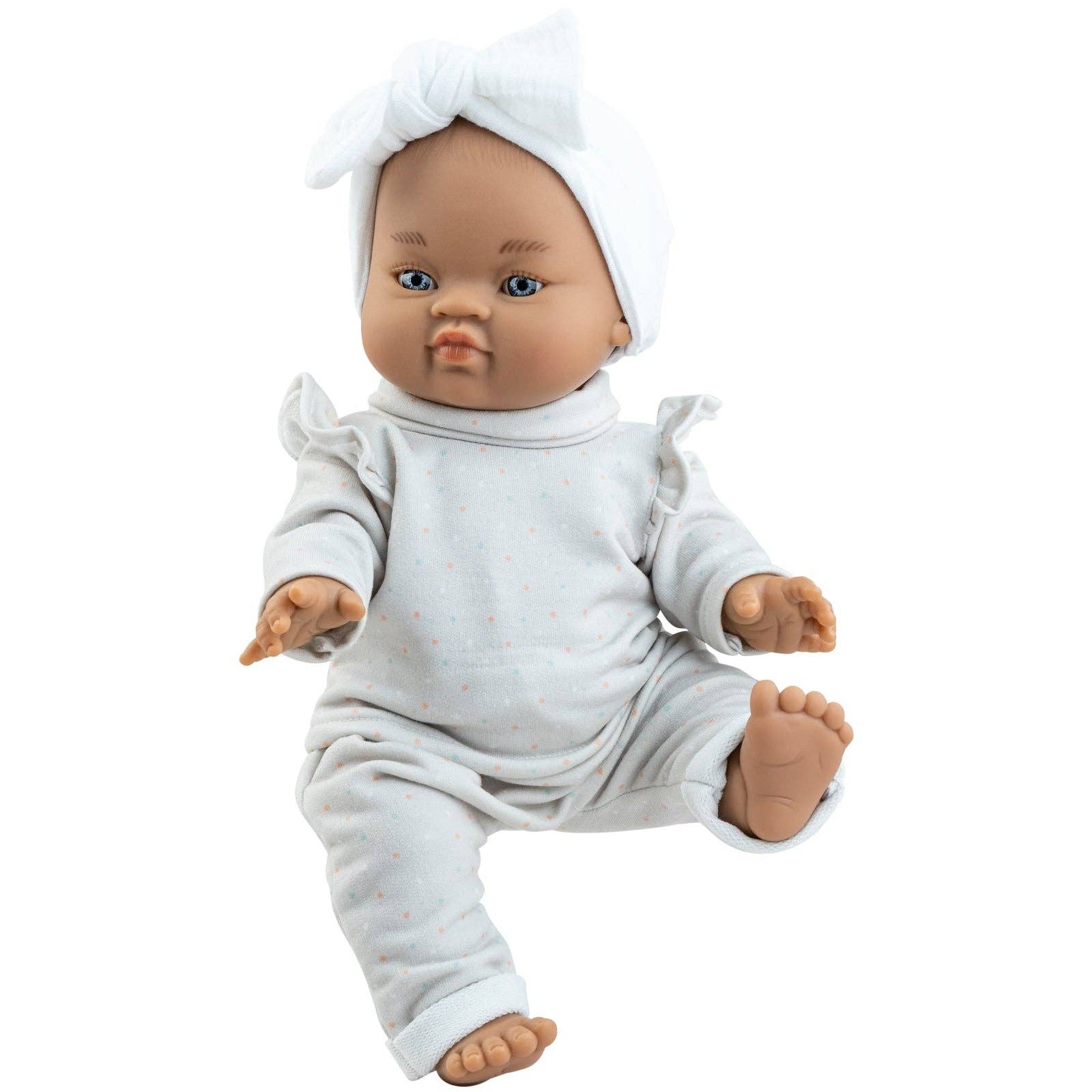 Baby doll wearing a white outfit and headband on a white background