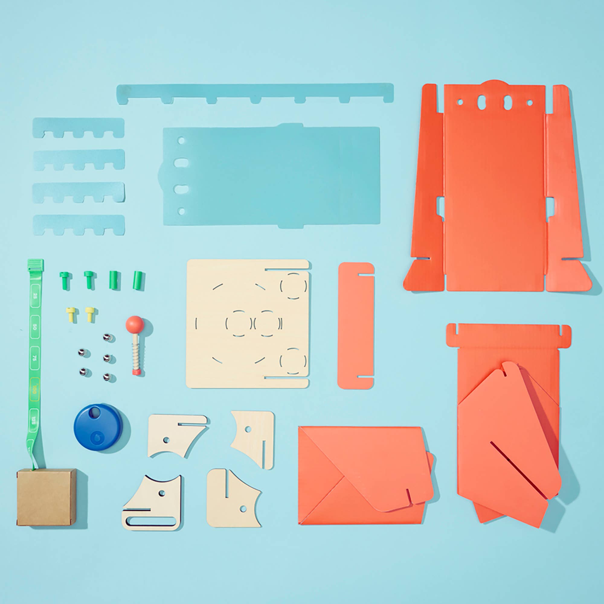 Set of craft materials including rulers, templates, and colored paper on a blue background