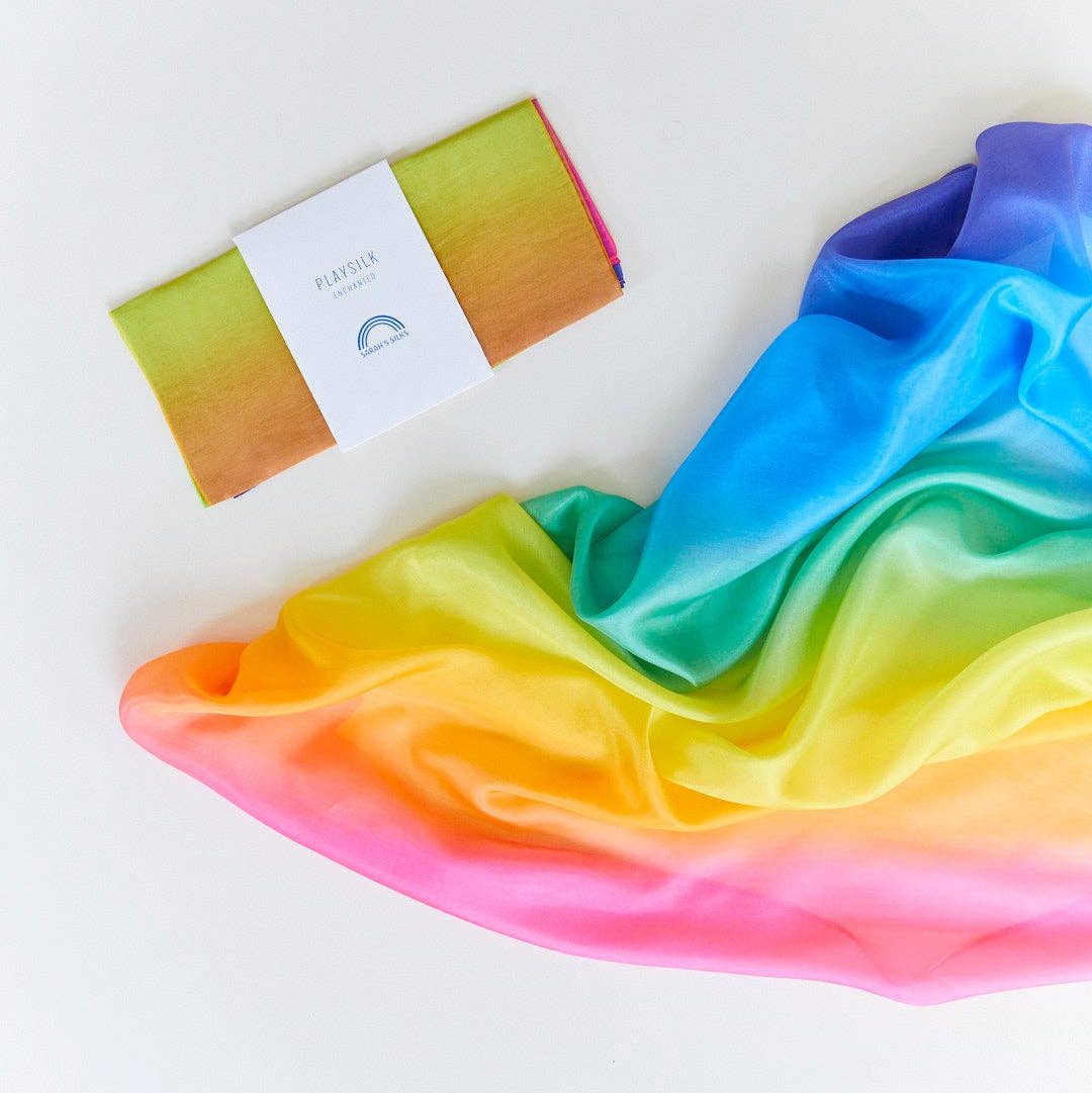 Rainbow-colored fabric with a brand label on a white background