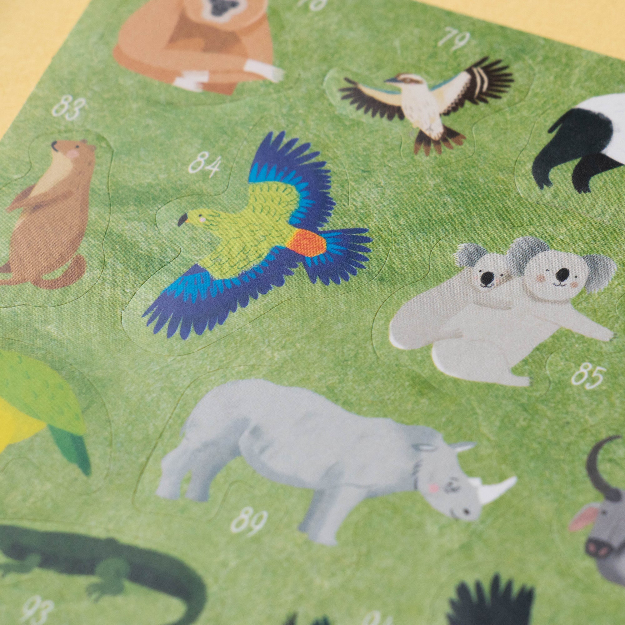Children's play mat with various animal illustrations on a green background