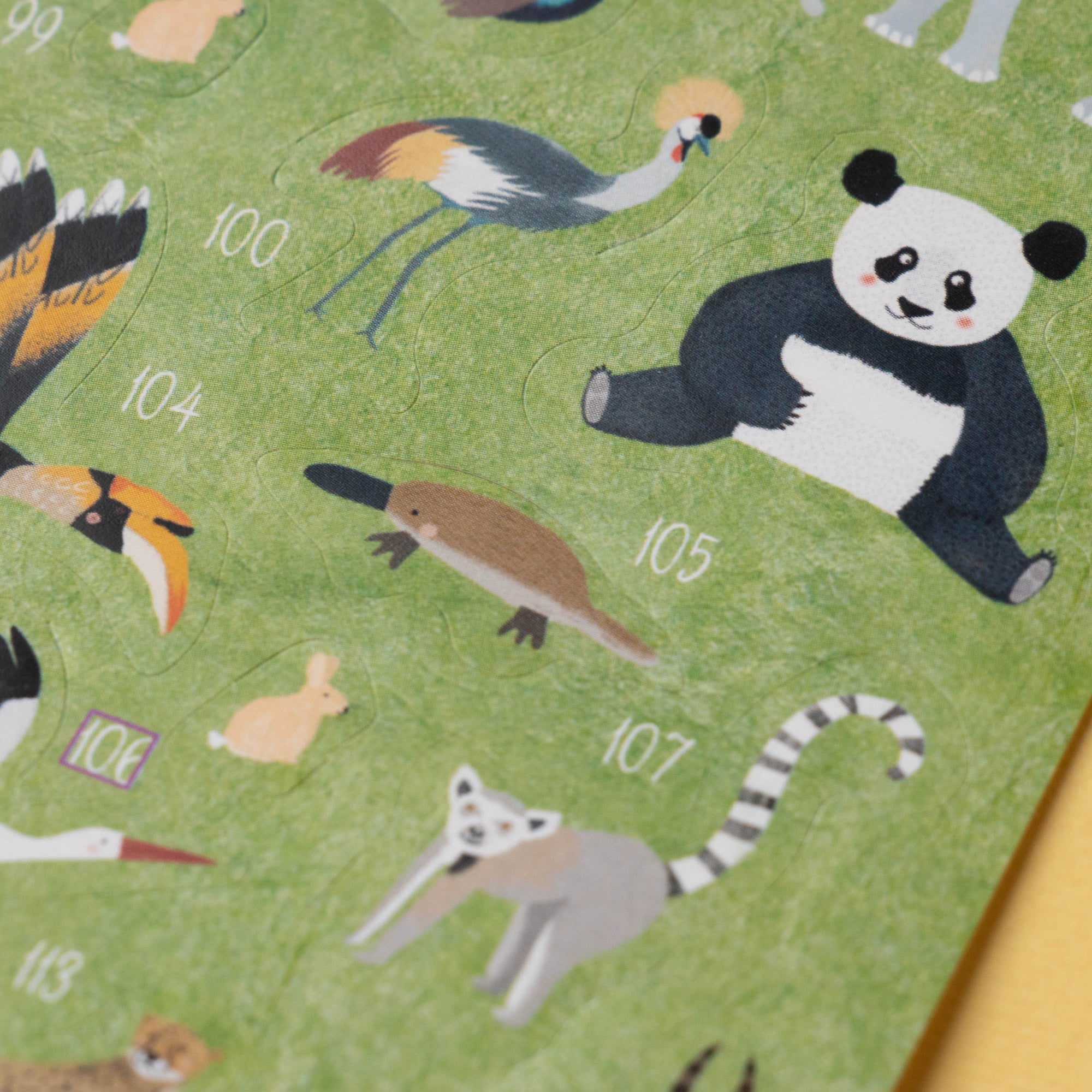 Children's educational chart with animal illustrations on a green background