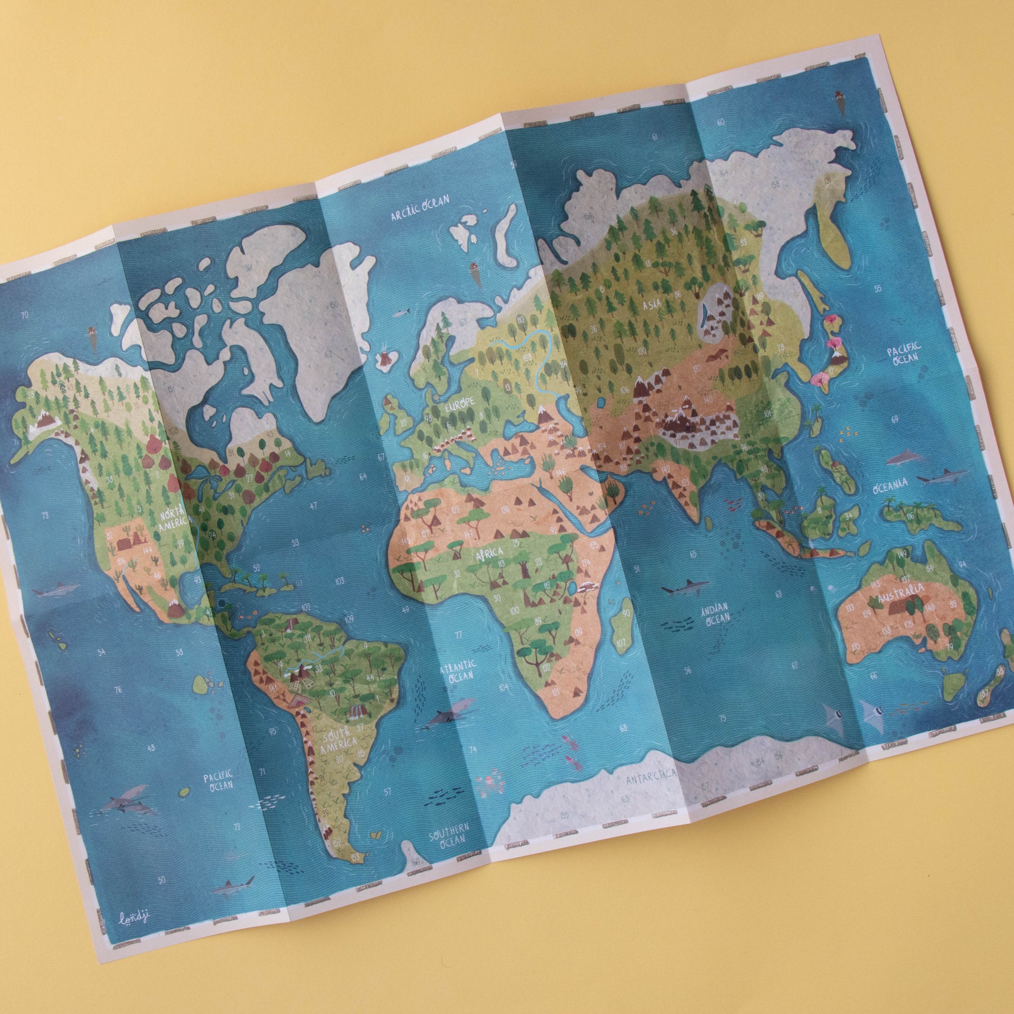 Foldable world map on a yellow background