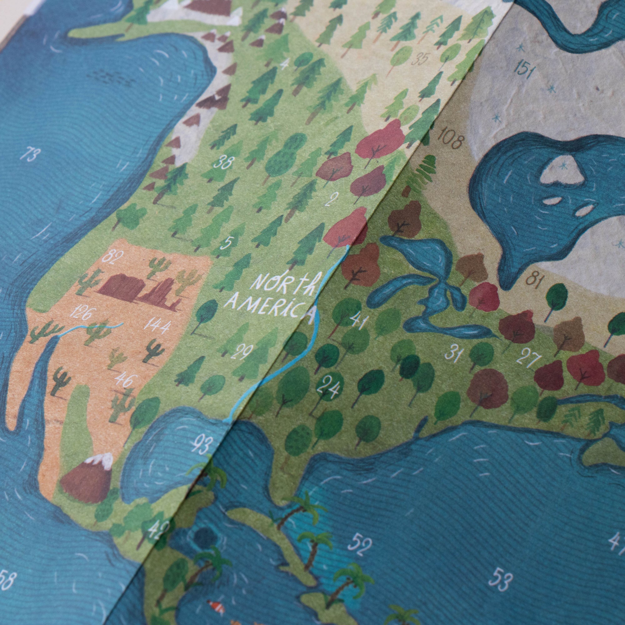 Children's map of North America with colorful landmasses and blue oceans.