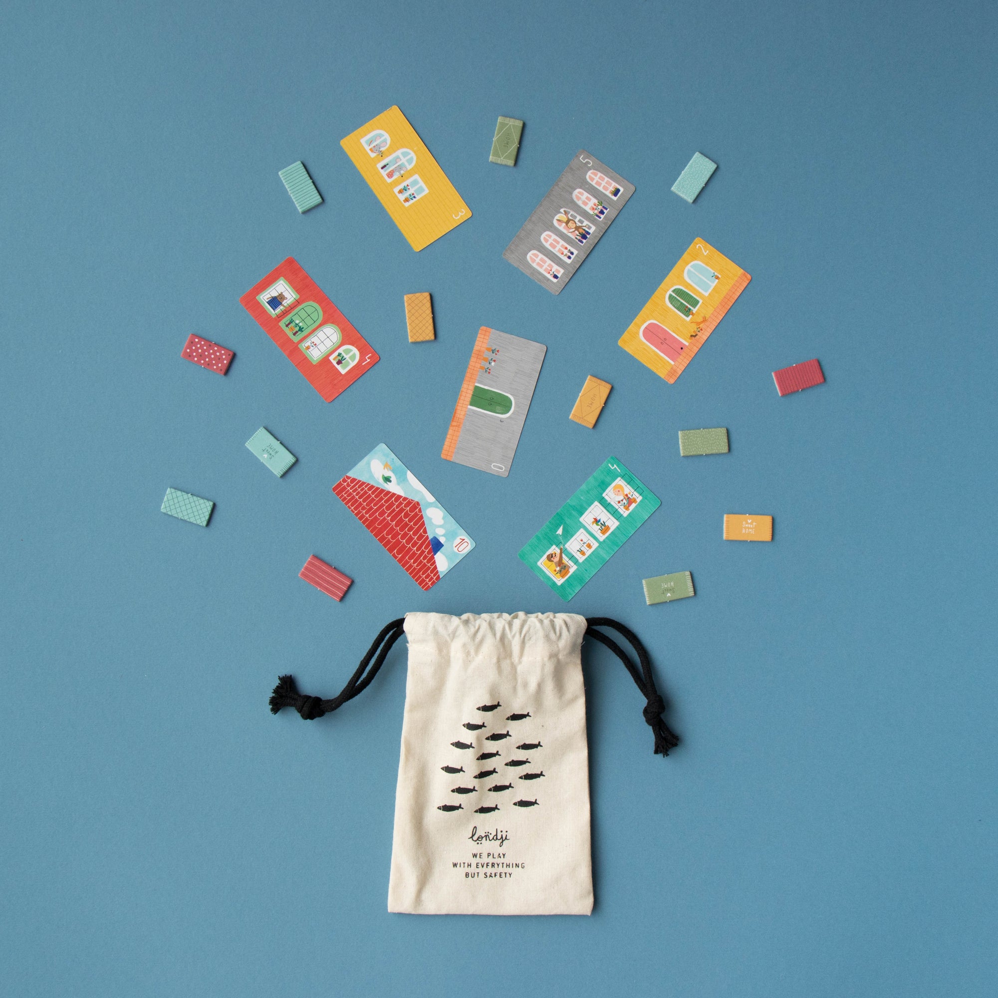 Colorful cards spilling out of a drawstring bag on a blue background