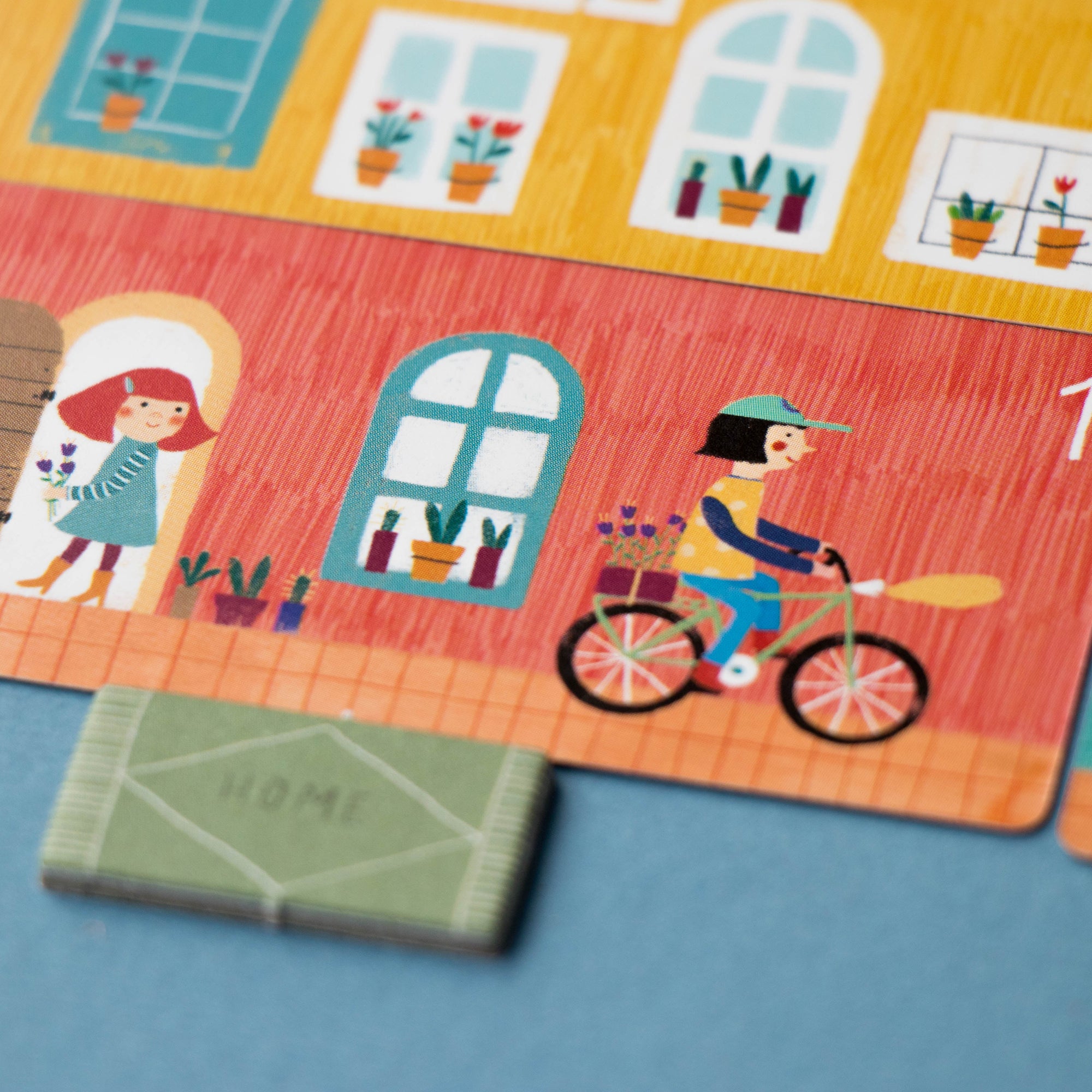 Colorful children's puzzle with house and bicycle design on a blue background