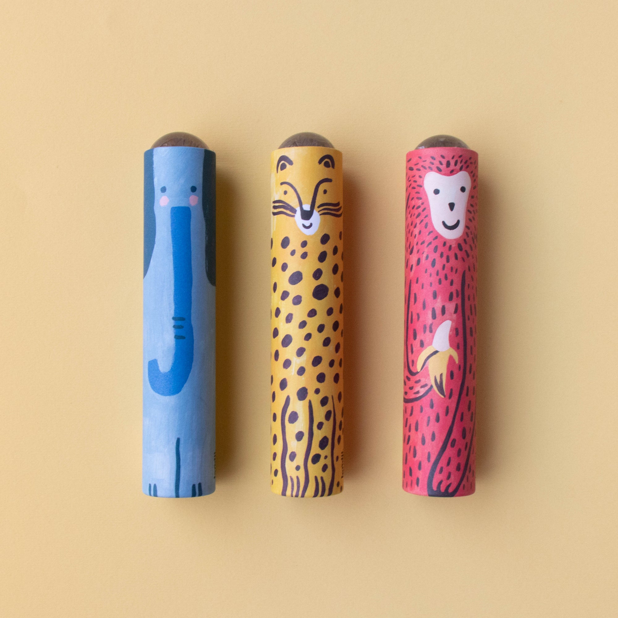 Three colorful rKaleidoscopes with animal faces on a beige background