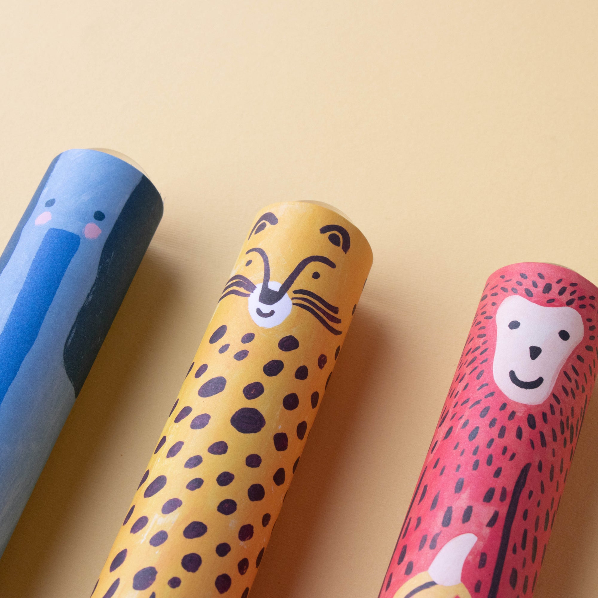 Three colorful Kaleidoscopes with animal designs on a beige background