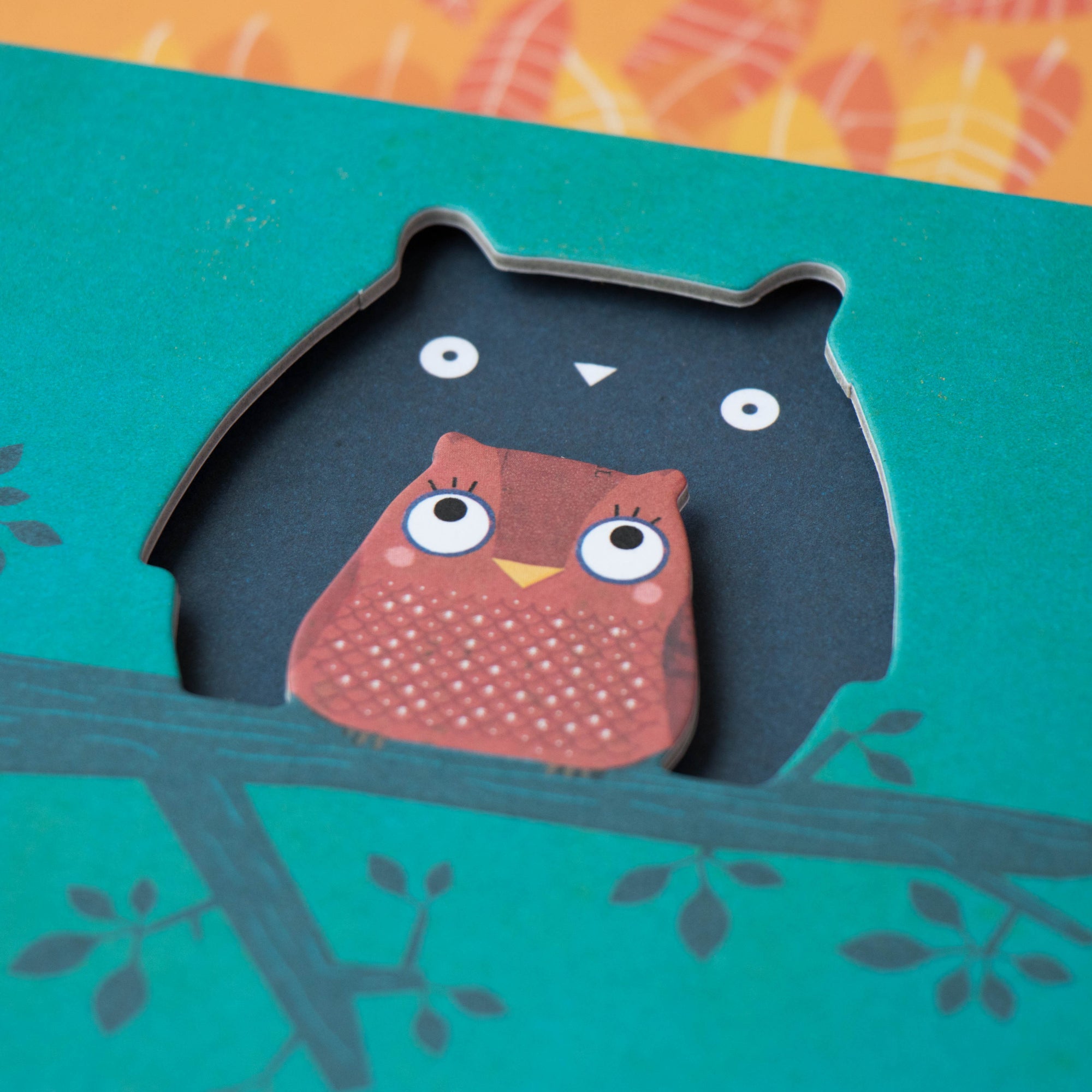 Card with cut-out owl design on a teal background