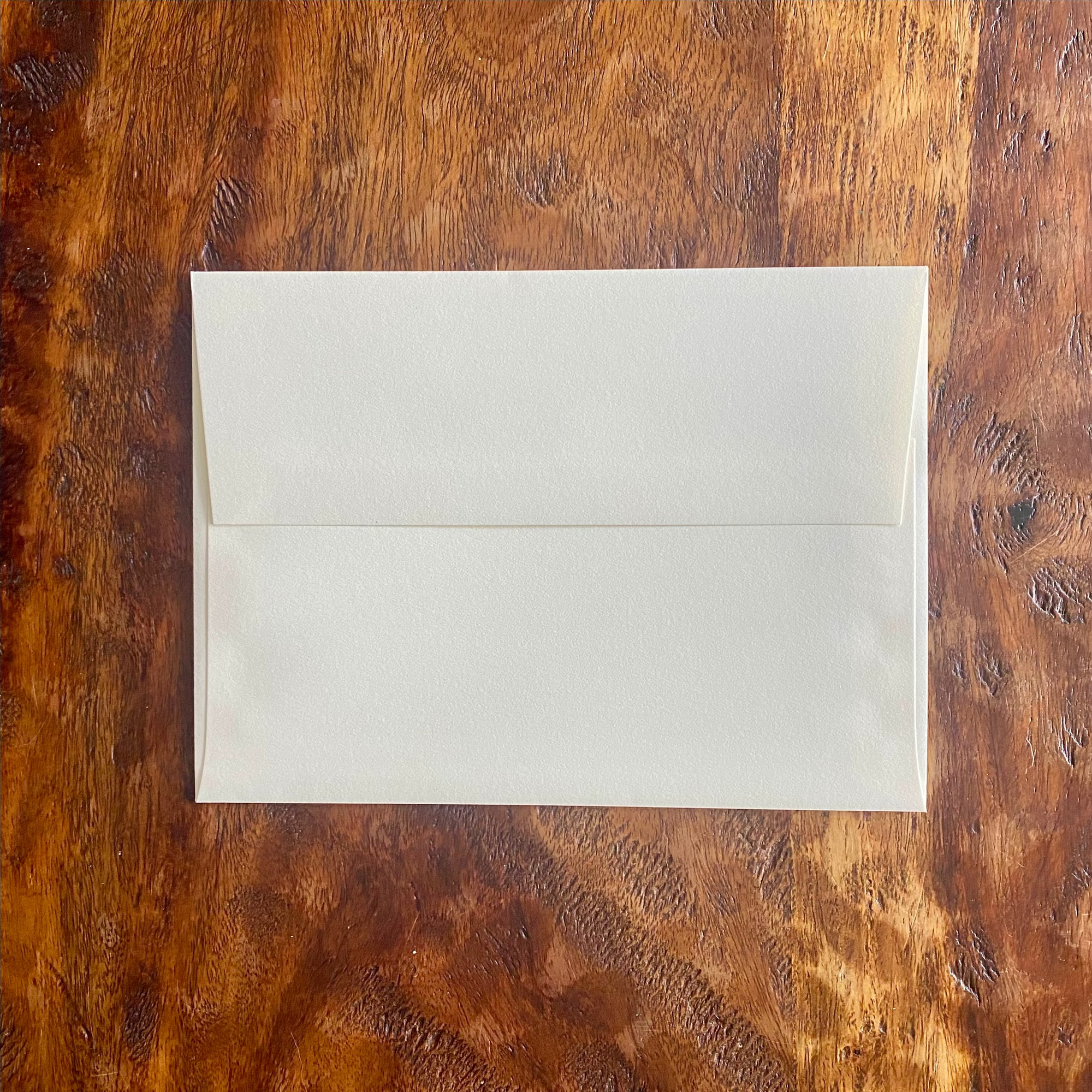 White envelope on a wooden surface