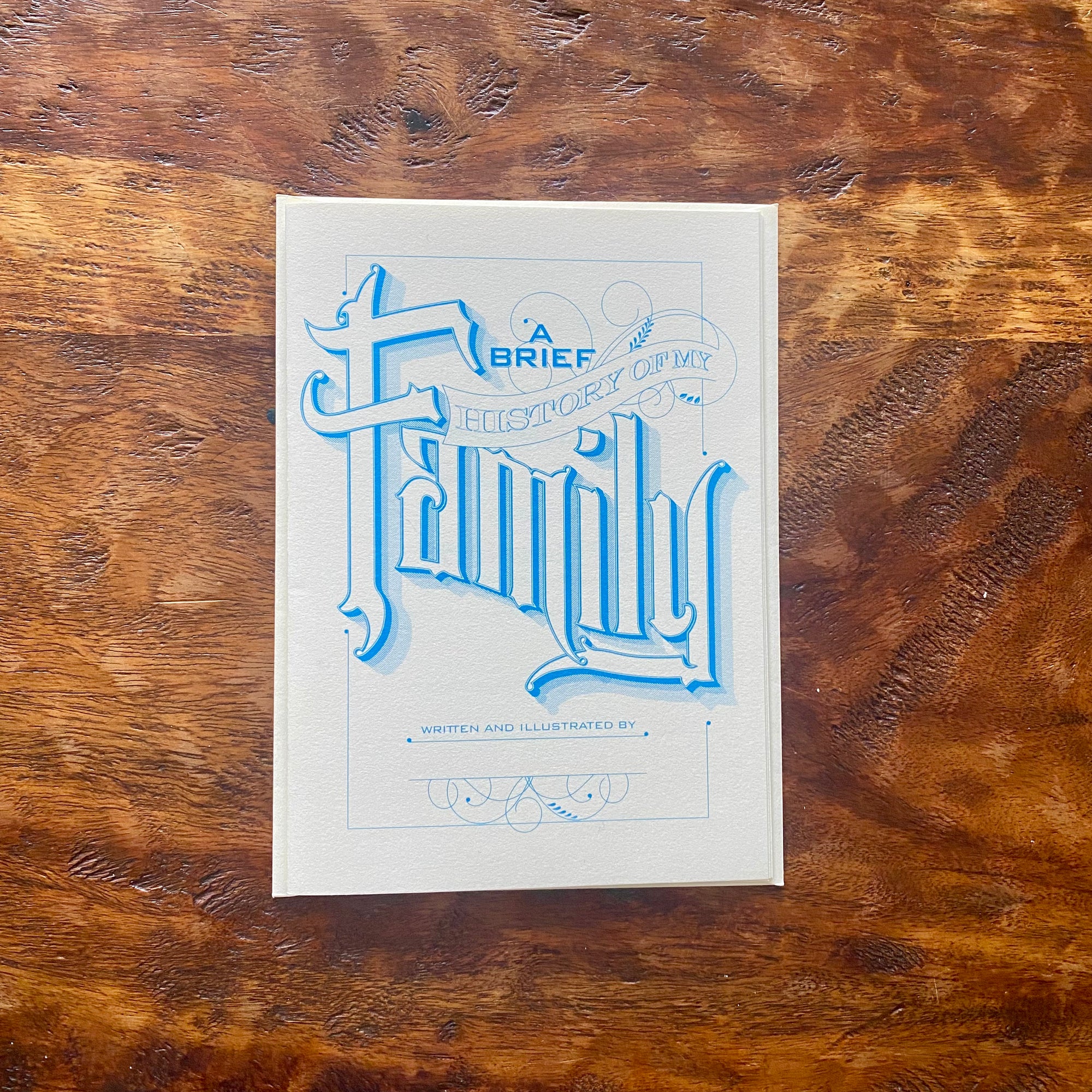 White book with blue text on a wooden surface