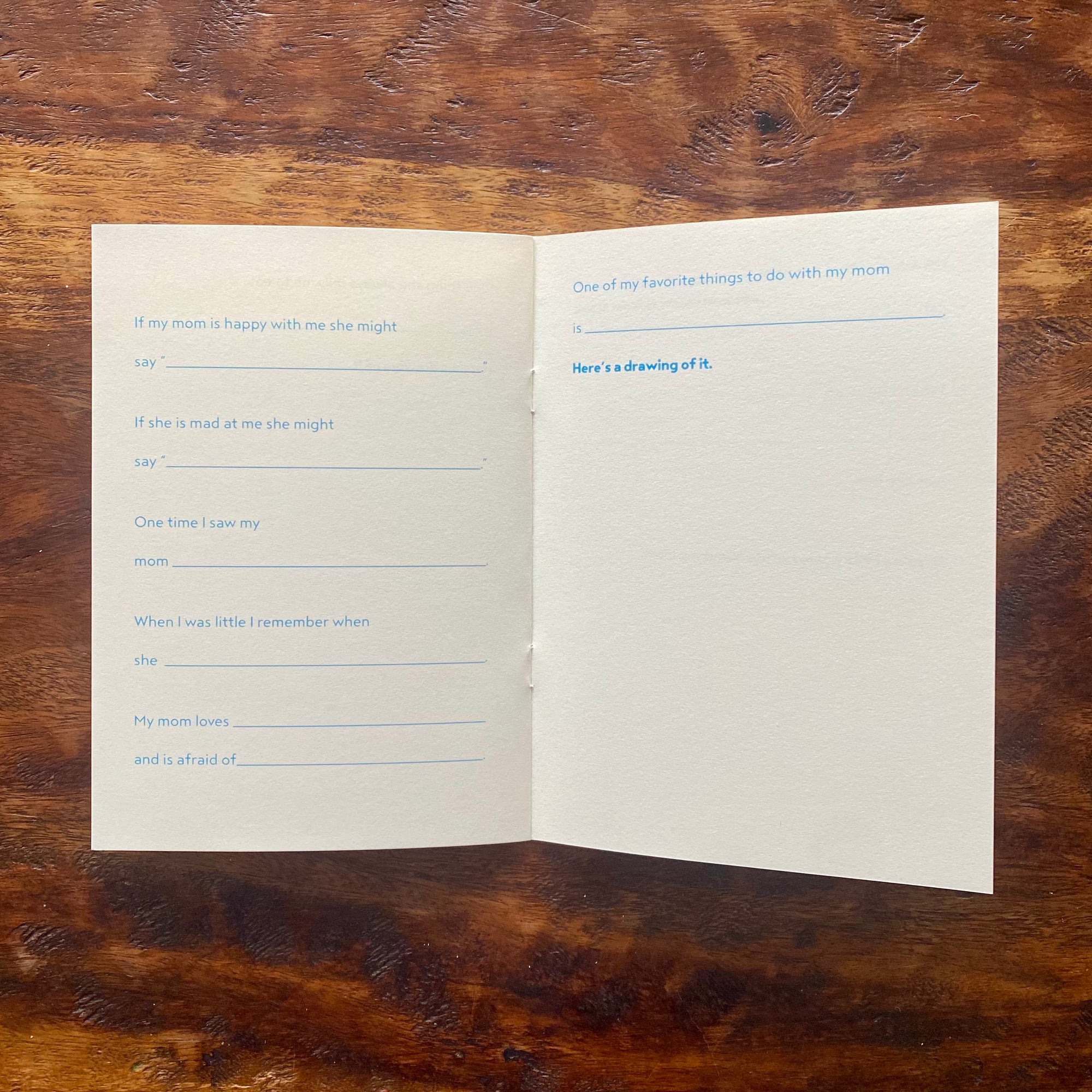 Open book with questionnaire on a wooden surface