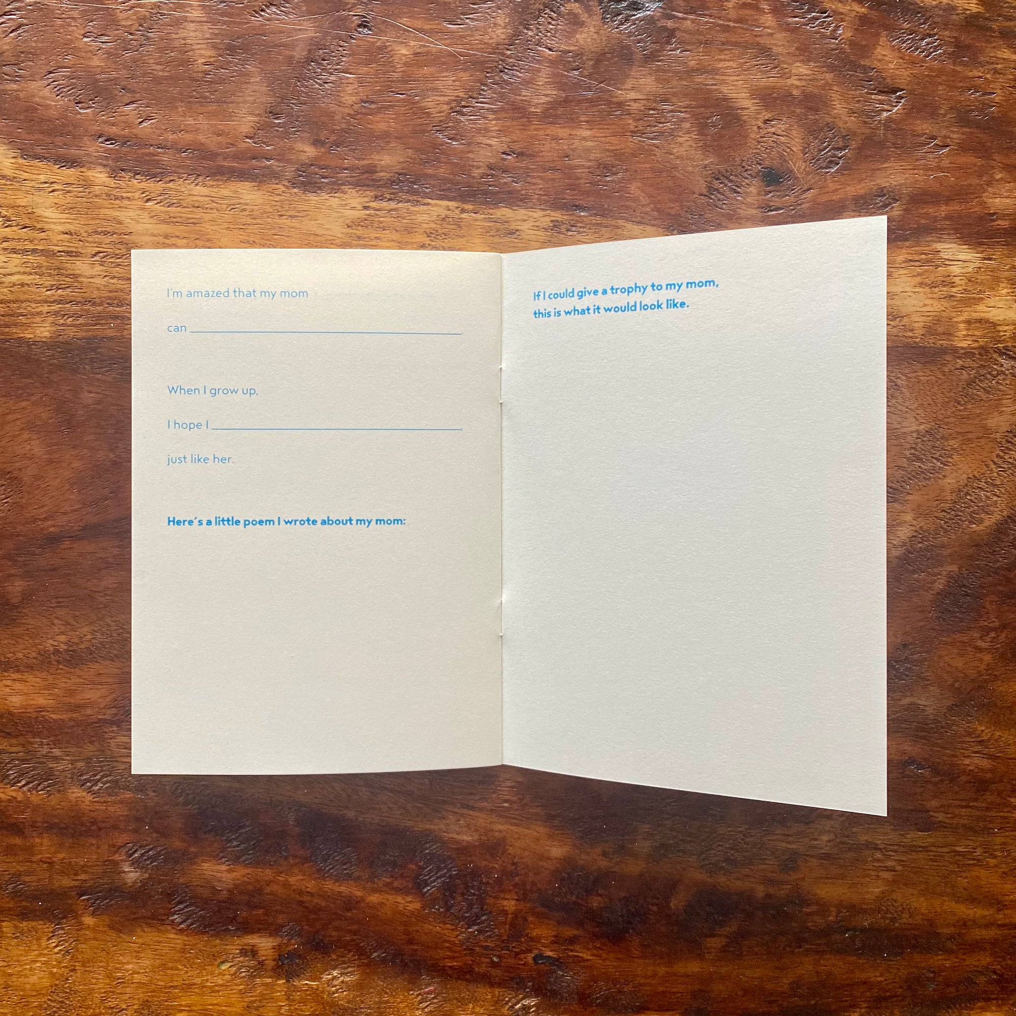 Open card with text on a wooden surface