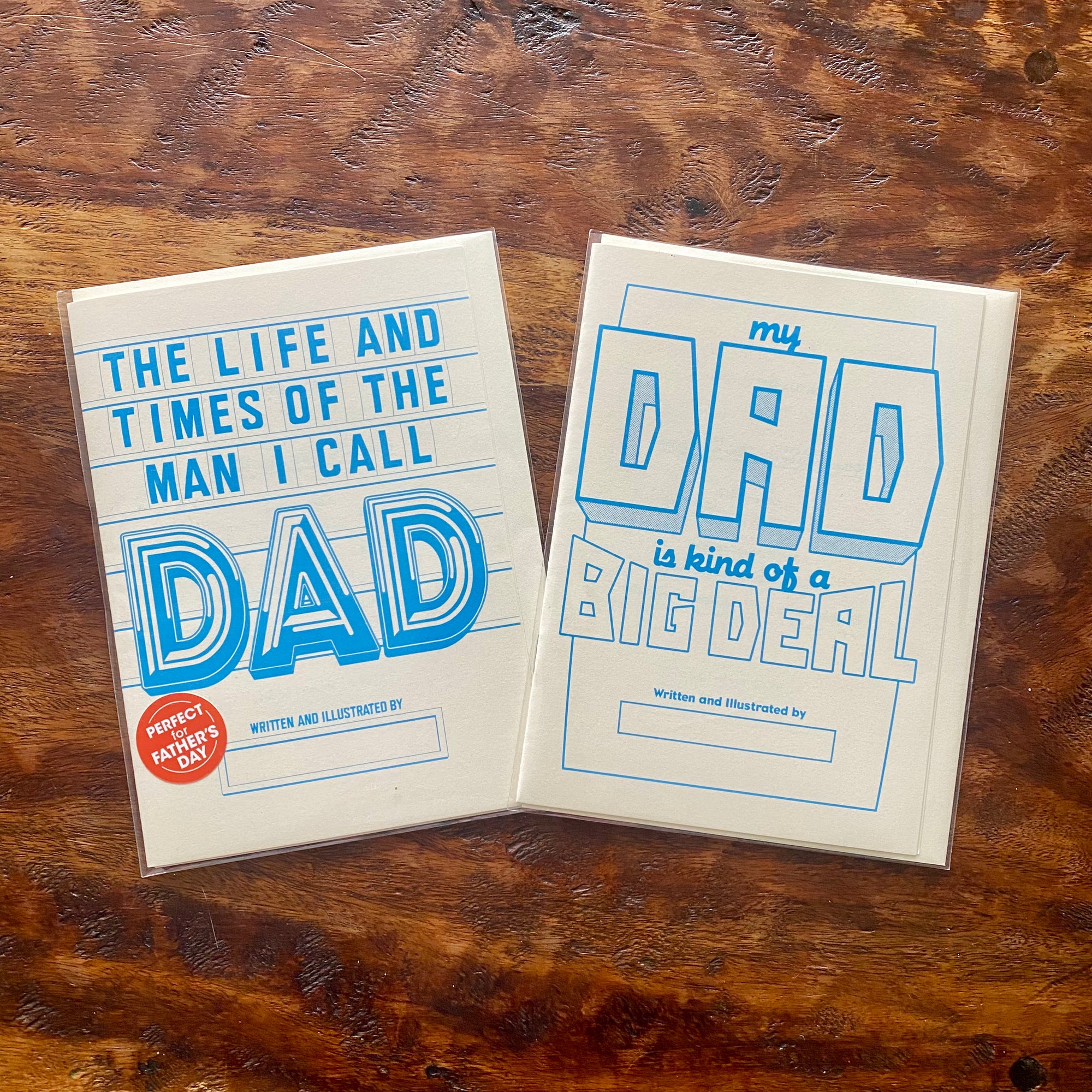Two Cards on a wooden surface with text about fathers.