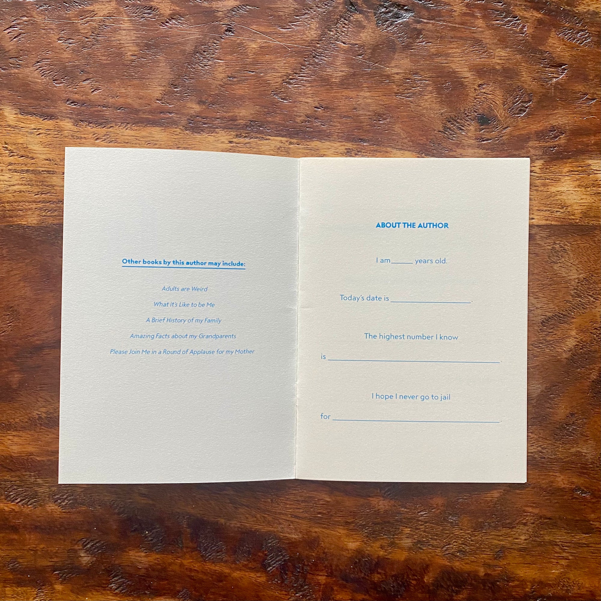 Open book on a wooden surface with text and questions.