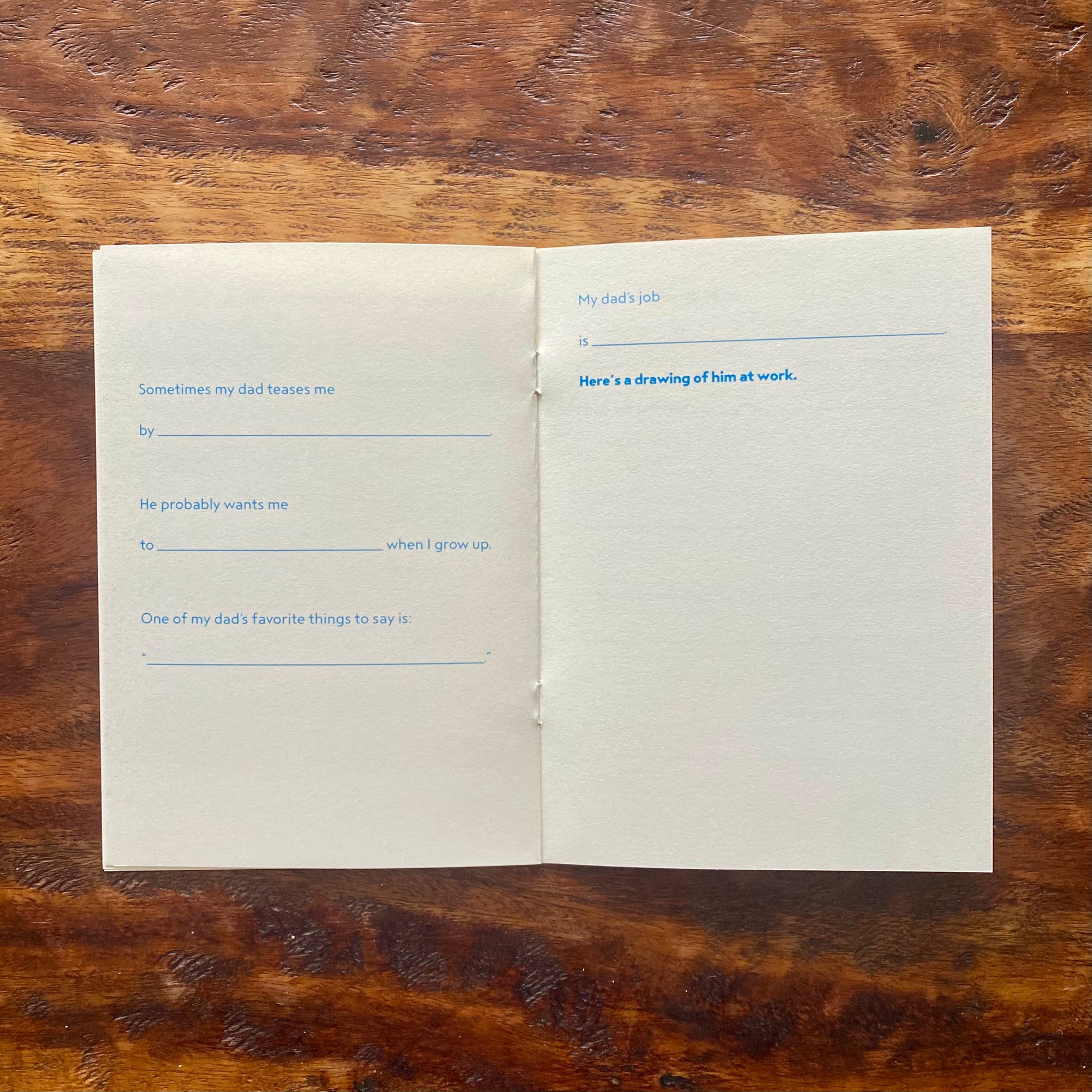 Open book with blank pages on a wooden surface