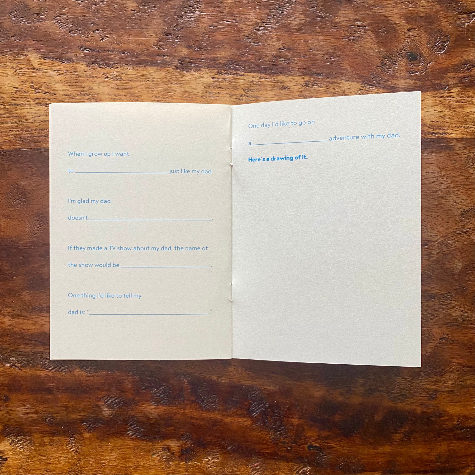 Open book with printed text on a wooden surface
