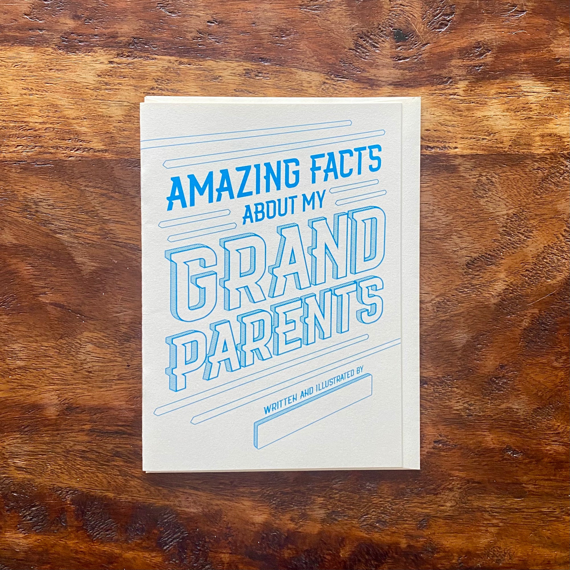 Card titled 'Amazing Facts About My Grandparents' on a wooden surface