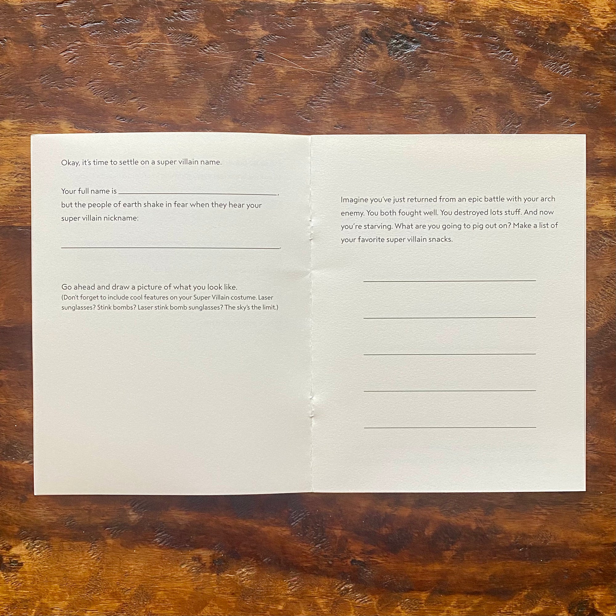 Blank paper with writing prompts on a wooden surface