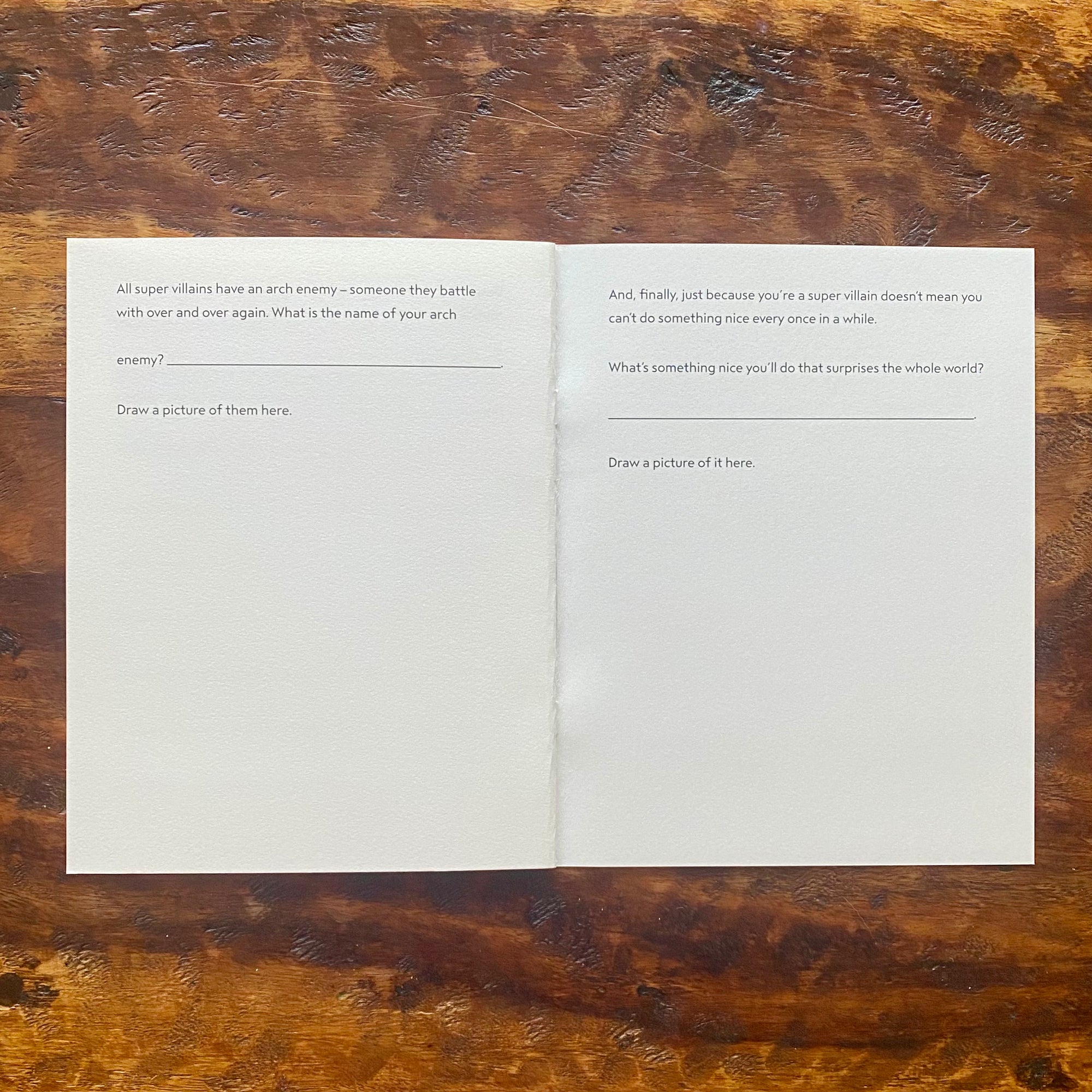 Open book with blank pages on a wooden surface
