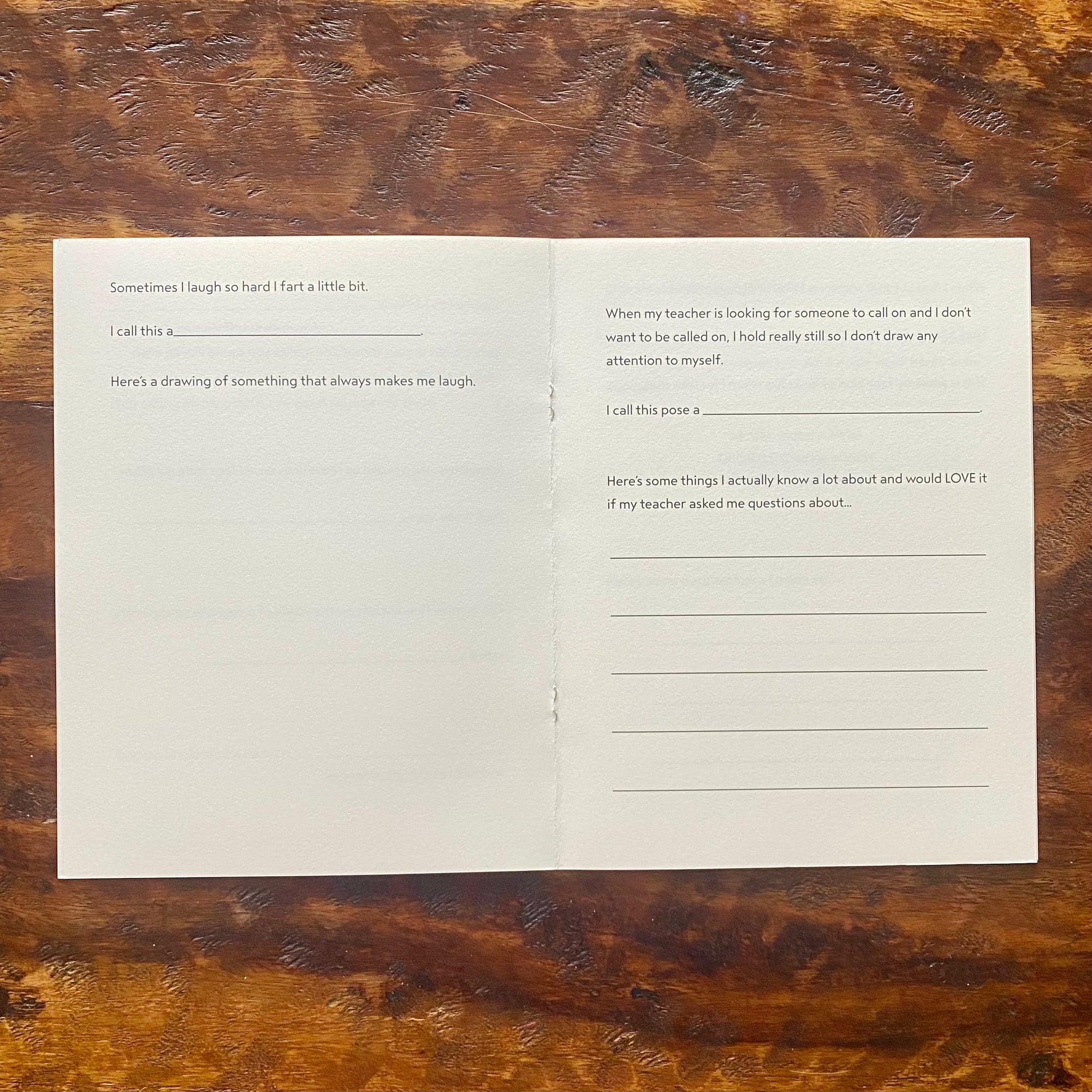 Folded paper with text and questions on a wooden surface