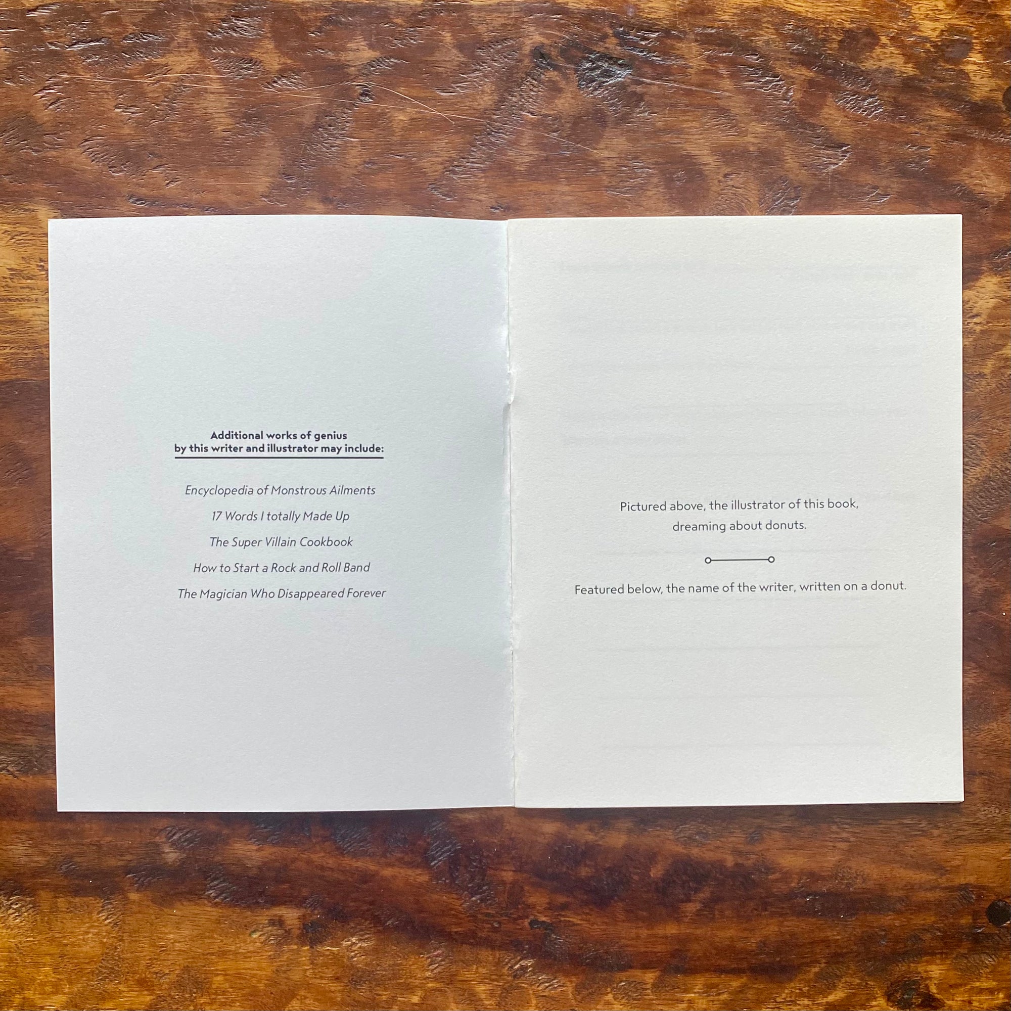 Open book on a wooden surface with text inside