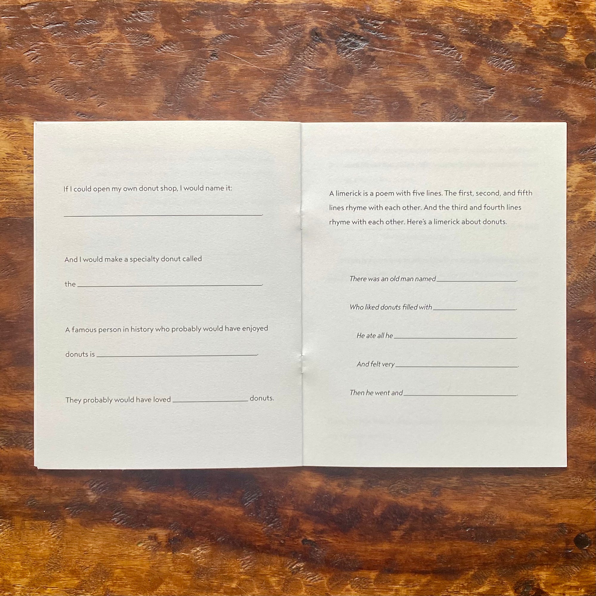 Open book with blank pages on a wooden surface