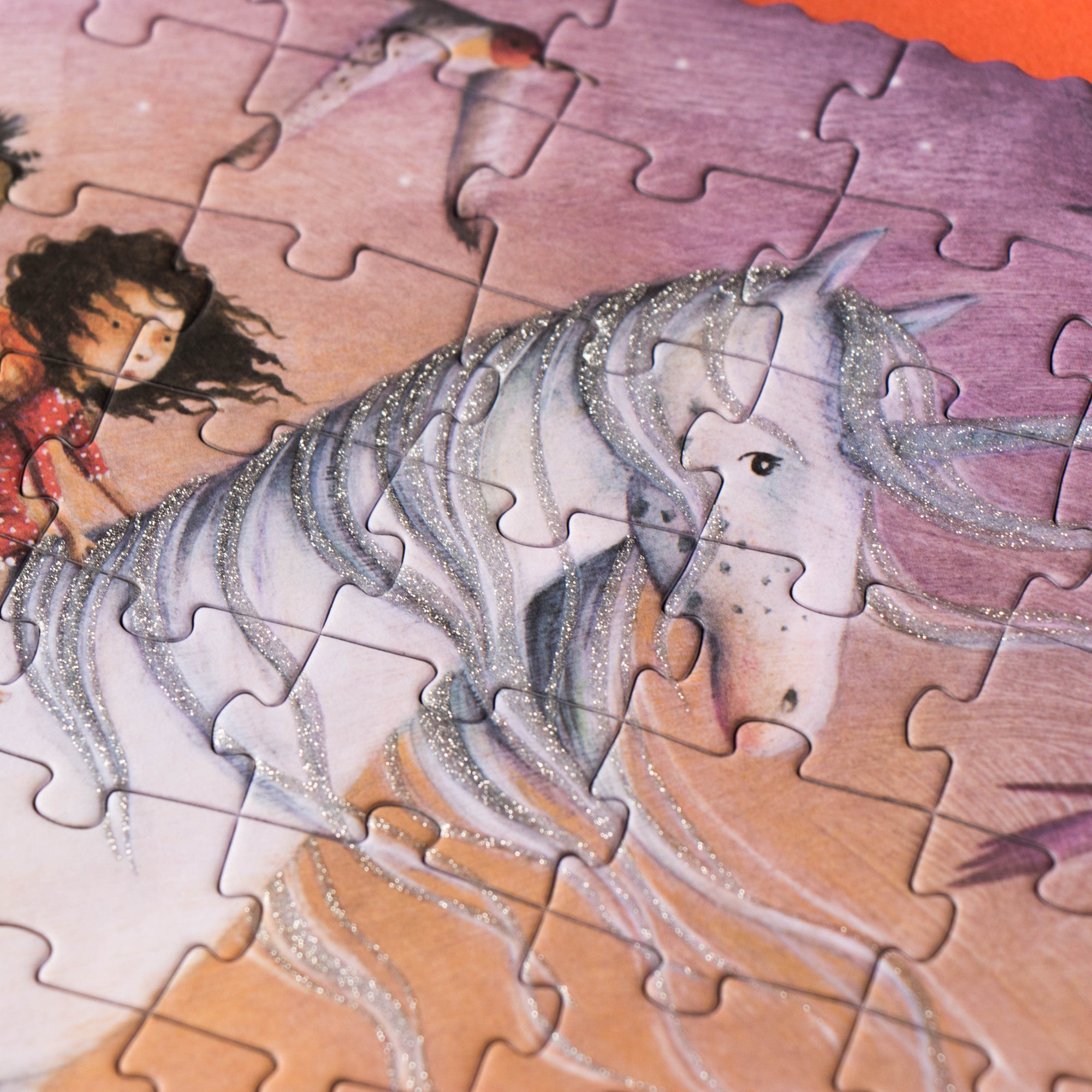 Unfinished puzzle with a fairy riding a unicorn on a colorful background