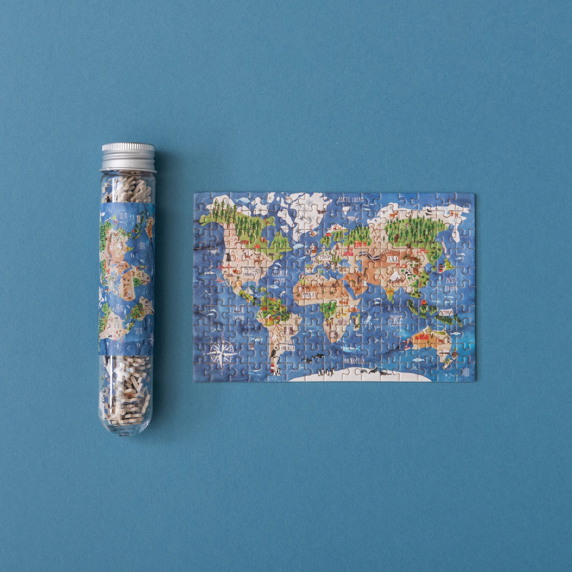 World map puzzle and packaging on a blue background