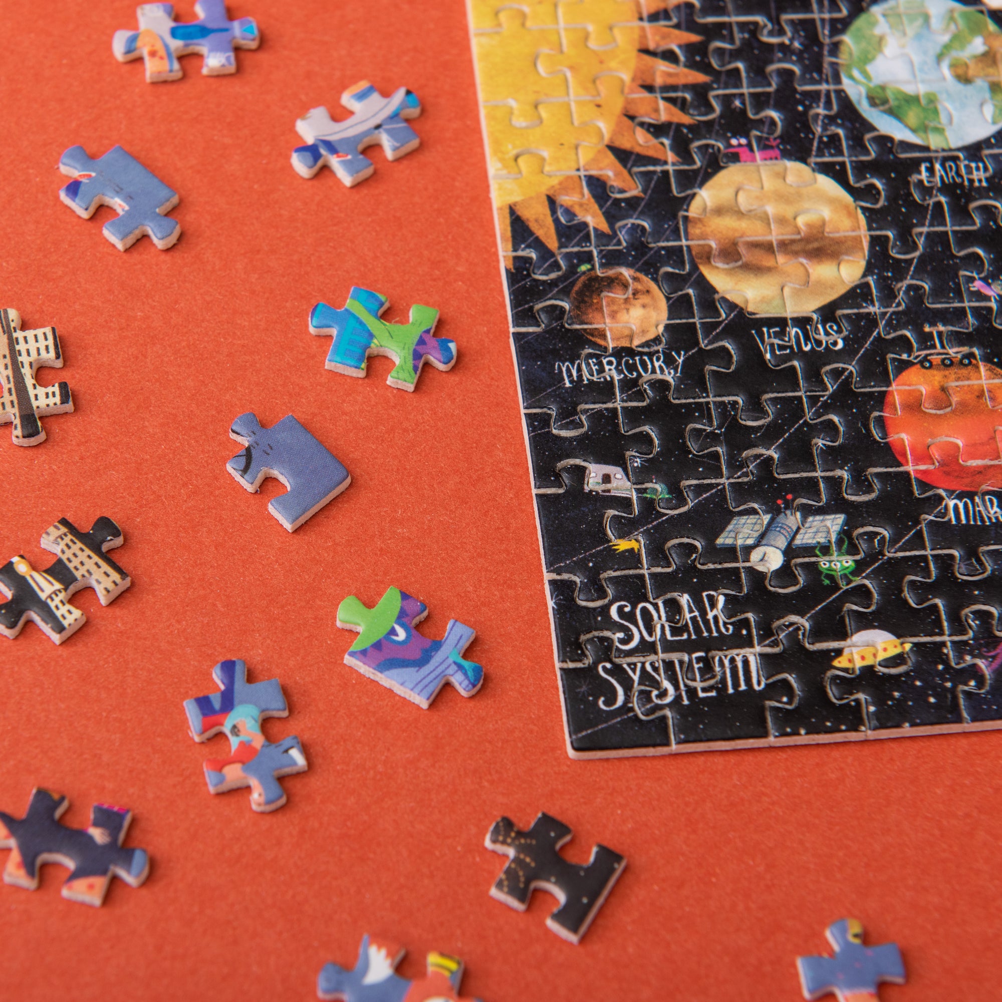 Solar system-themed puzzle with missing pieces on a red background