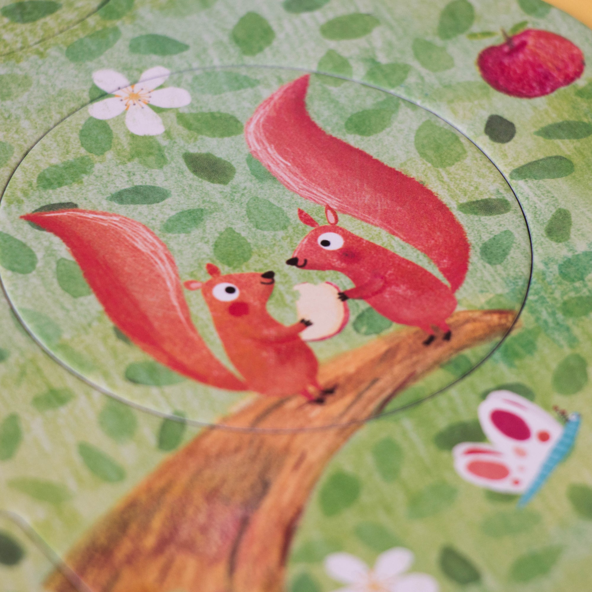 Coaster with red fox design on a green floral background