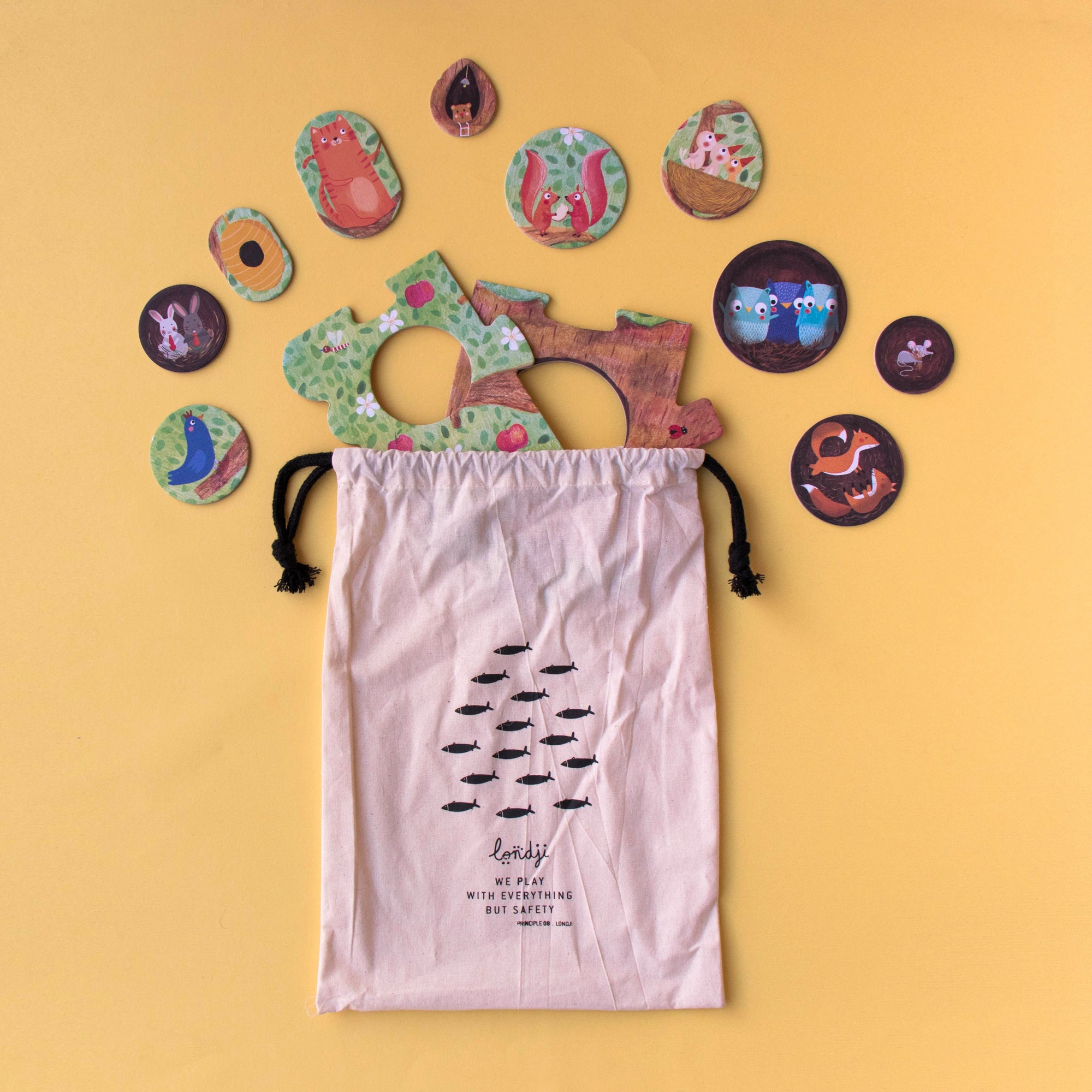 Colorful animal-shaped play discs with a drawstring bag on a yellow background