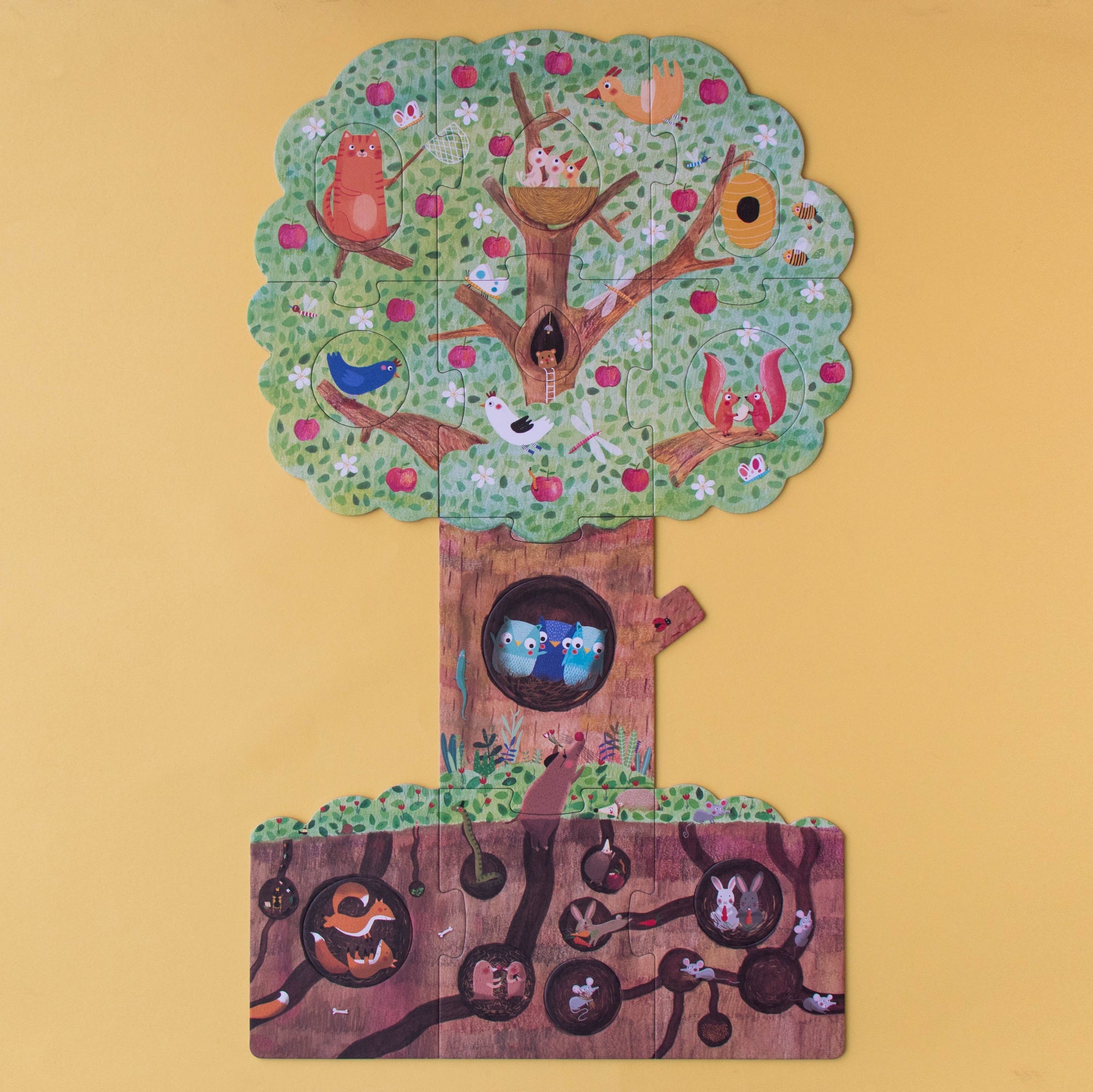 Colorful tree-shaped puzzle game with various compartments on a yellow background