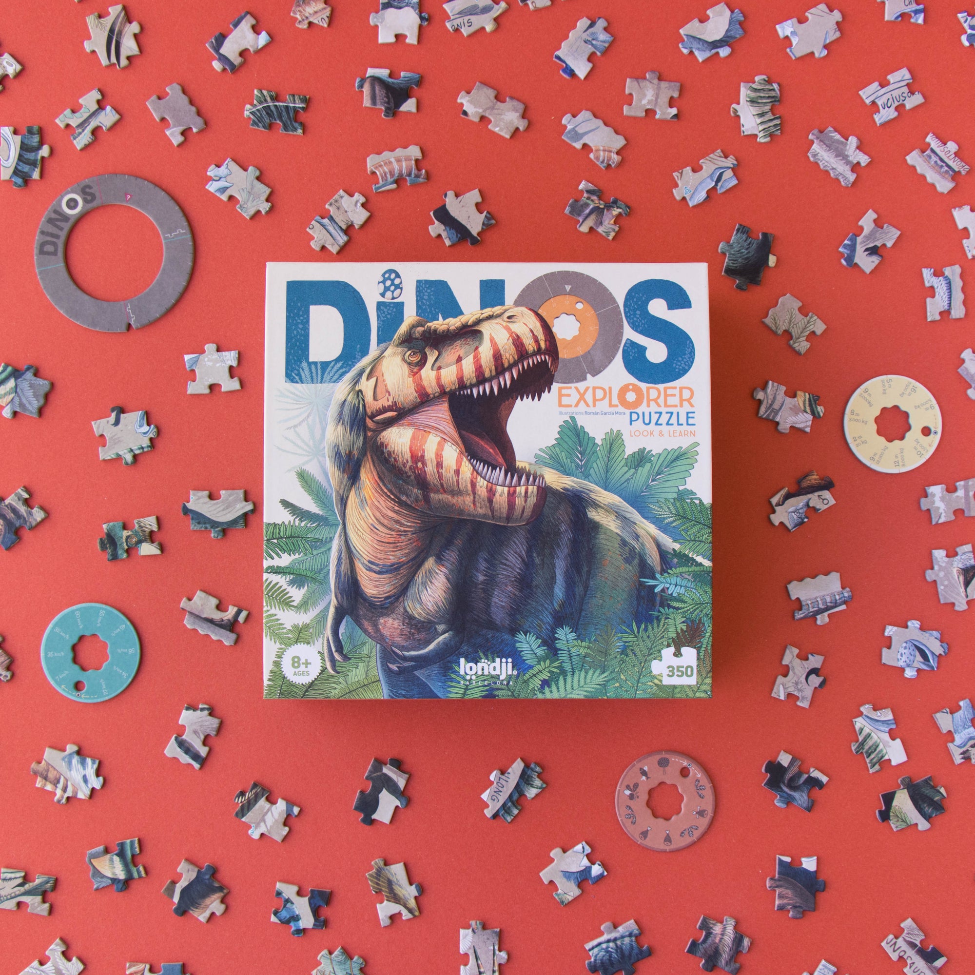 Dinosaur puzzle with pieces scattered on a red background
