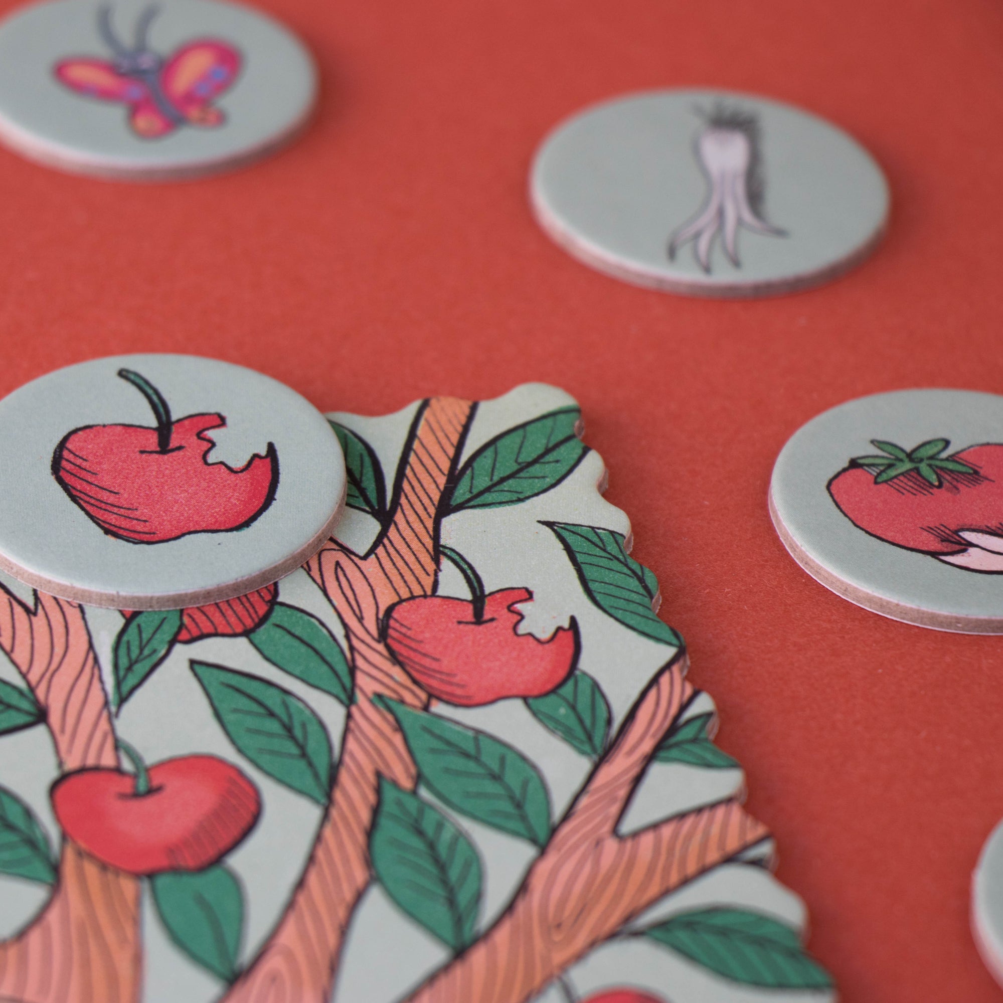 Decorative buttons with apple designs on a red background