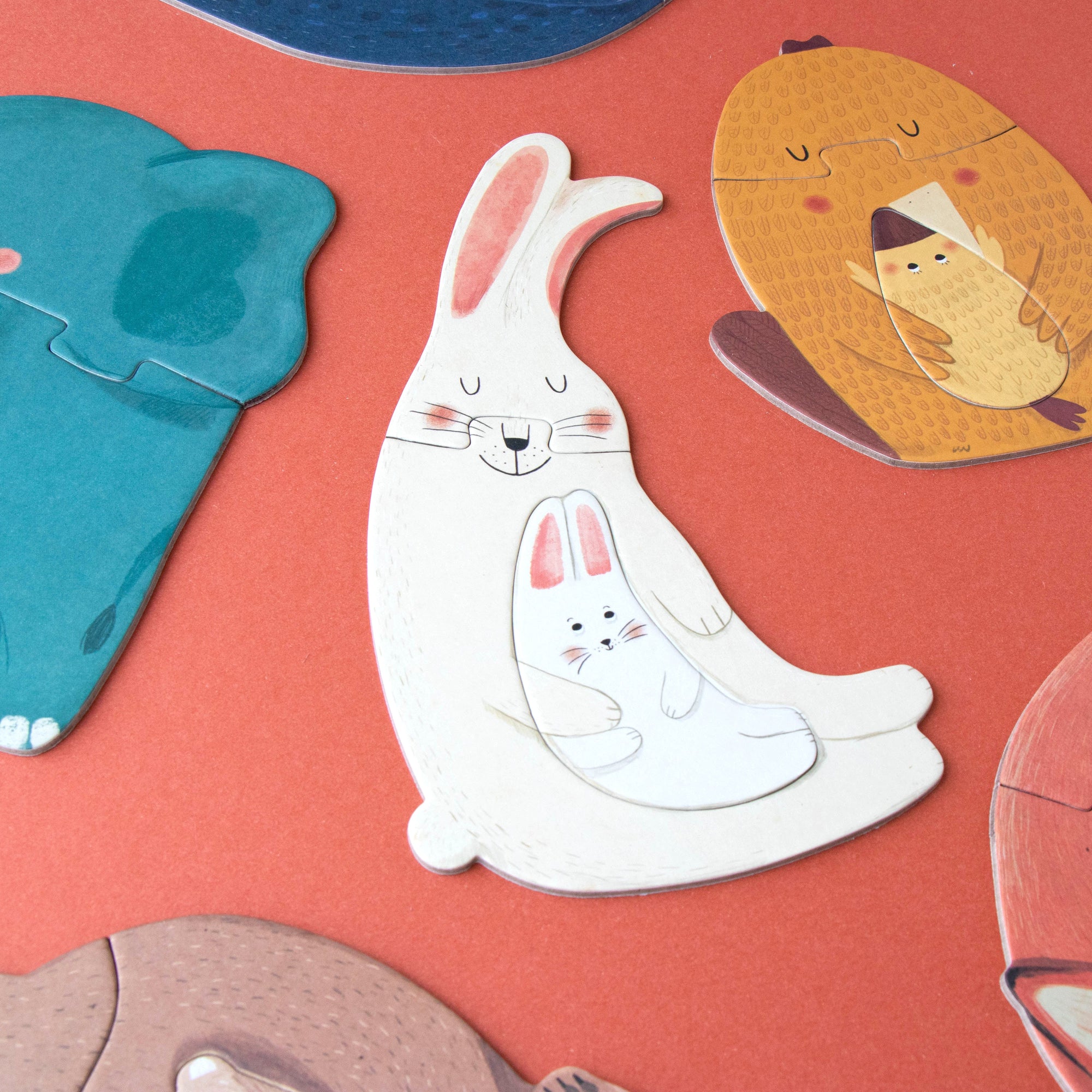 Cartoon animal puzzle pieces on a red background