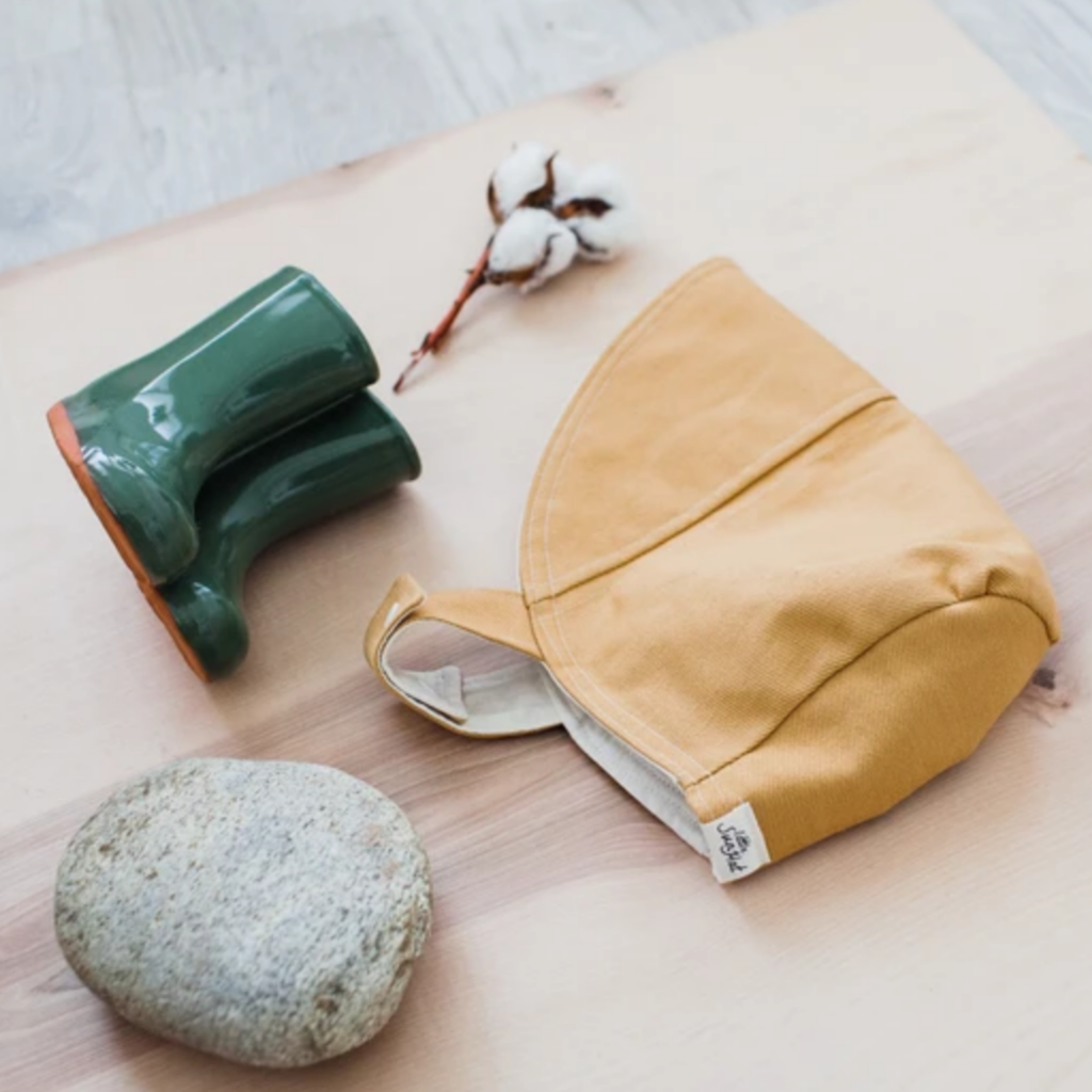 yuellow sun bonnet with cotton twig, green rain shoes and rock