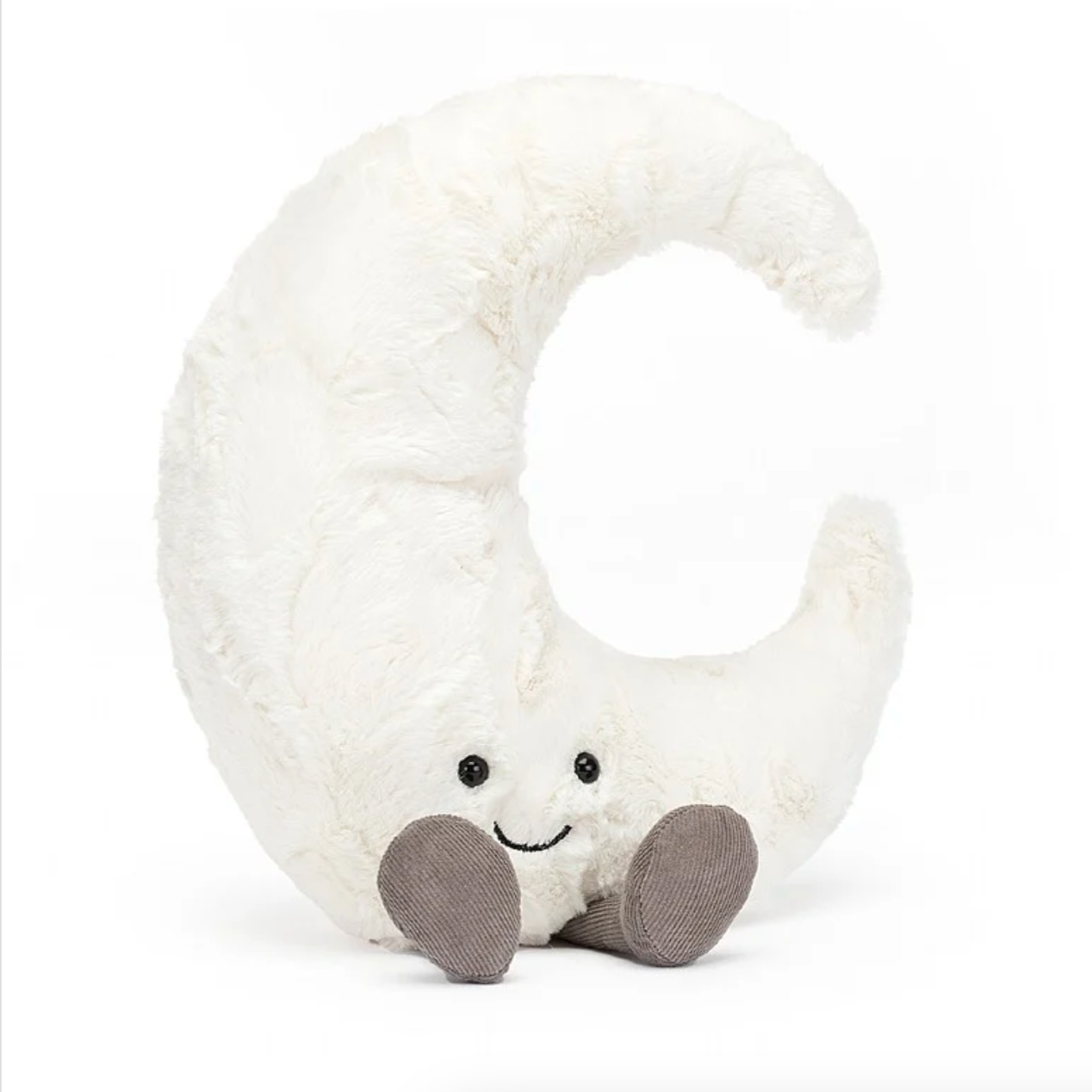 A large plush toy shaped like a crescent moon with a smiling face and grey feet.