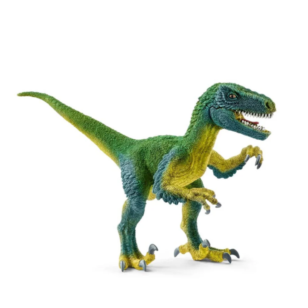 A toy figurine of a Velociraptor dinosaur with green and yellow coloring, posed with an open mouth showing sharp teeth.