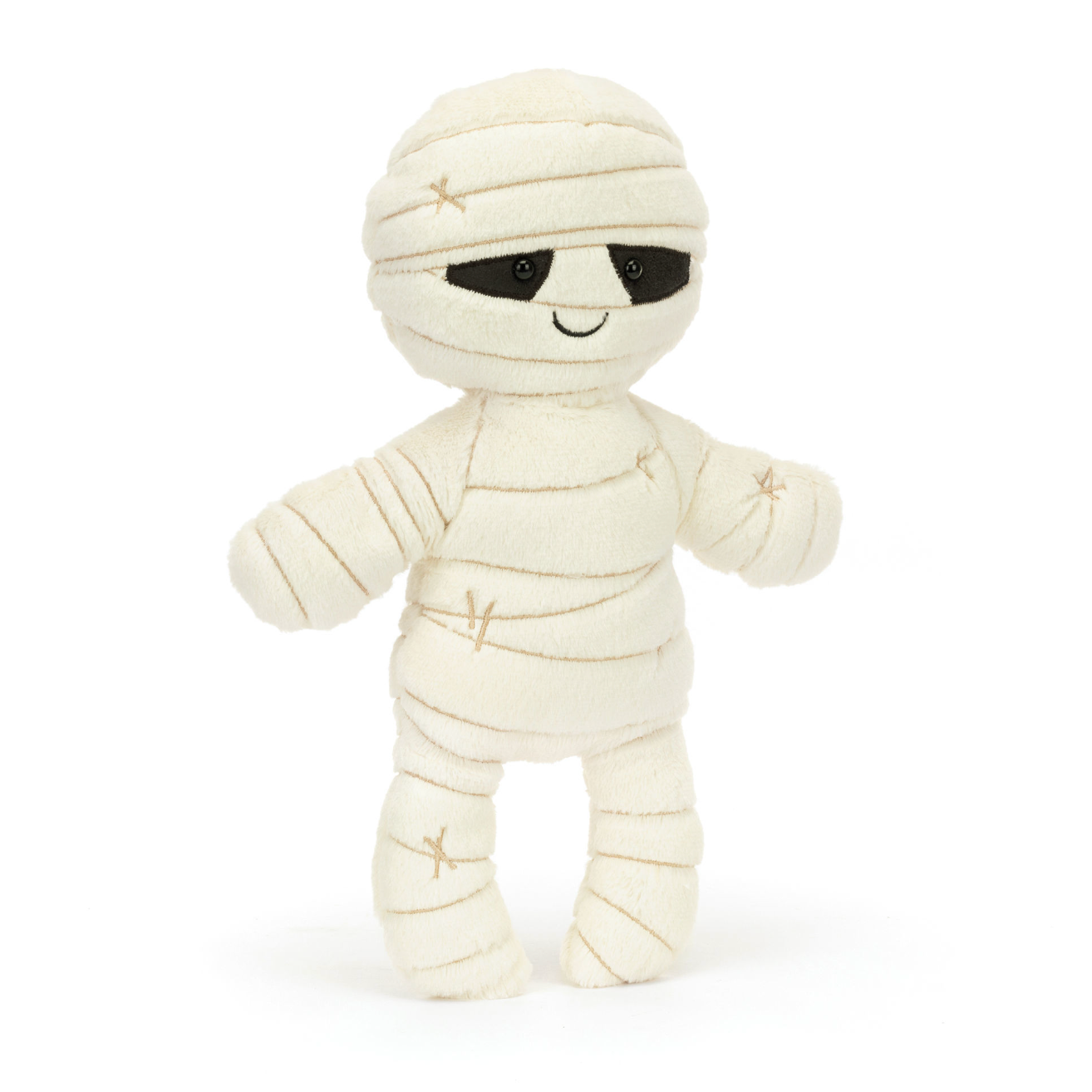 A plush toy designed as a mummy wrapped in bandages with embroidered details, with black eyes peeking out from the bandages.