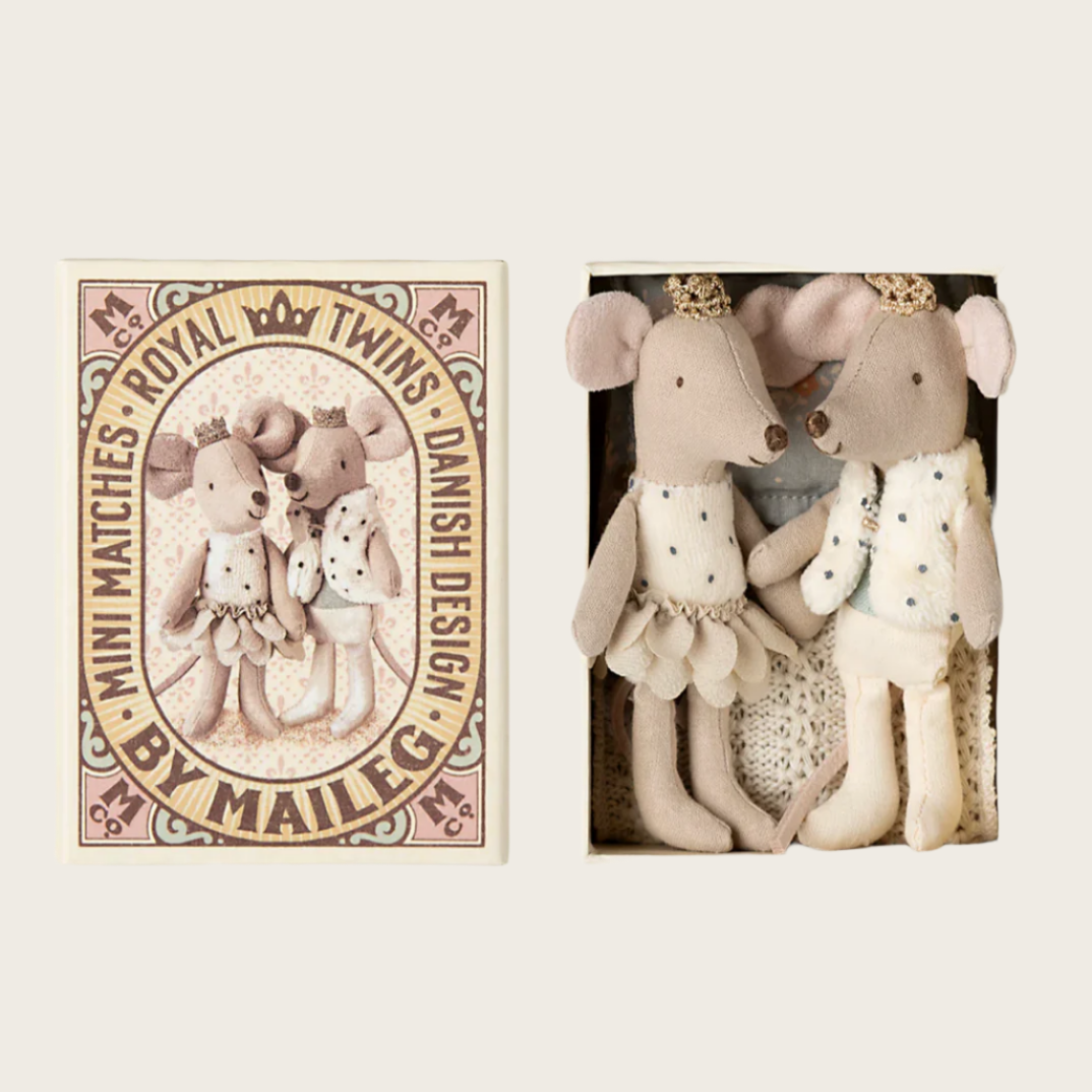 A set of two toy mice, one dressed as a princess and the other as a prince, wearing golden crowns and colorful clothes, sleeping in a decorated matchbox with the text 'Royal Twins' on the front.