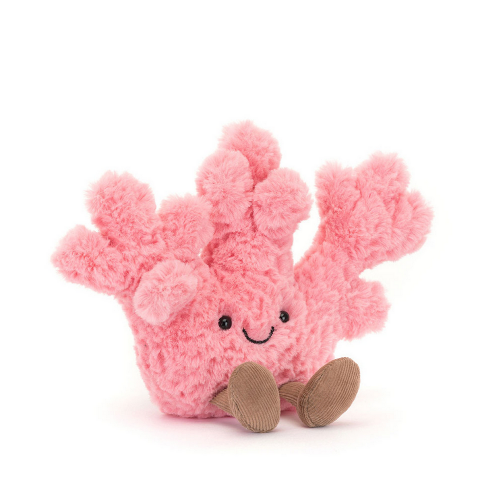 Pink plush coral toy on a white background
