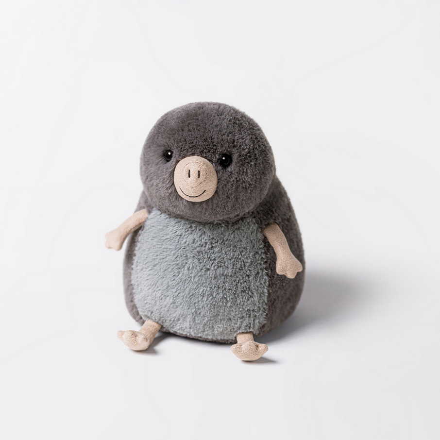 Plush toy mole named Muswell Mole on a white background.