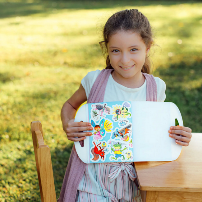 Young girl holding a tray with stickers outdoors