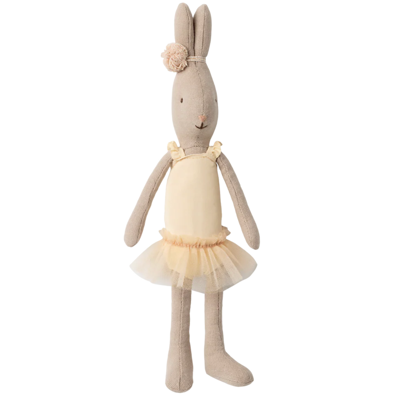 Stuffed bunny toy with a yellow dress on a white background